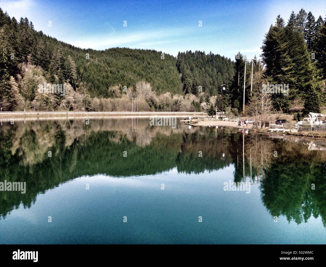 The landscape is almost perfectly mirrored in the lake in the foreground. - Smartphone Captured Stock Image
