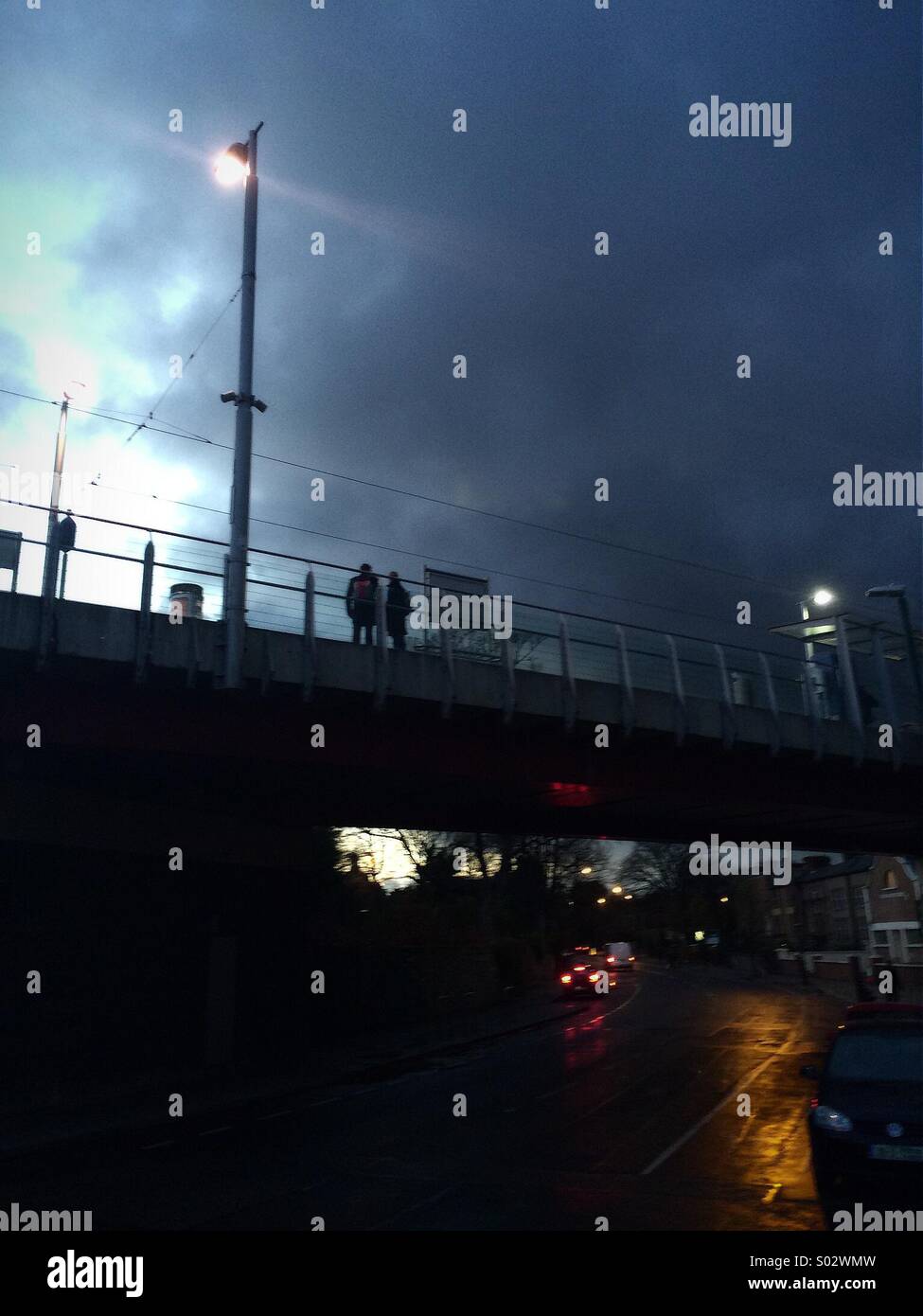 A dark cloud over the tramline bridge in Ranelagh, Dublin, Ireland. - Smartphone Captured Stock Image