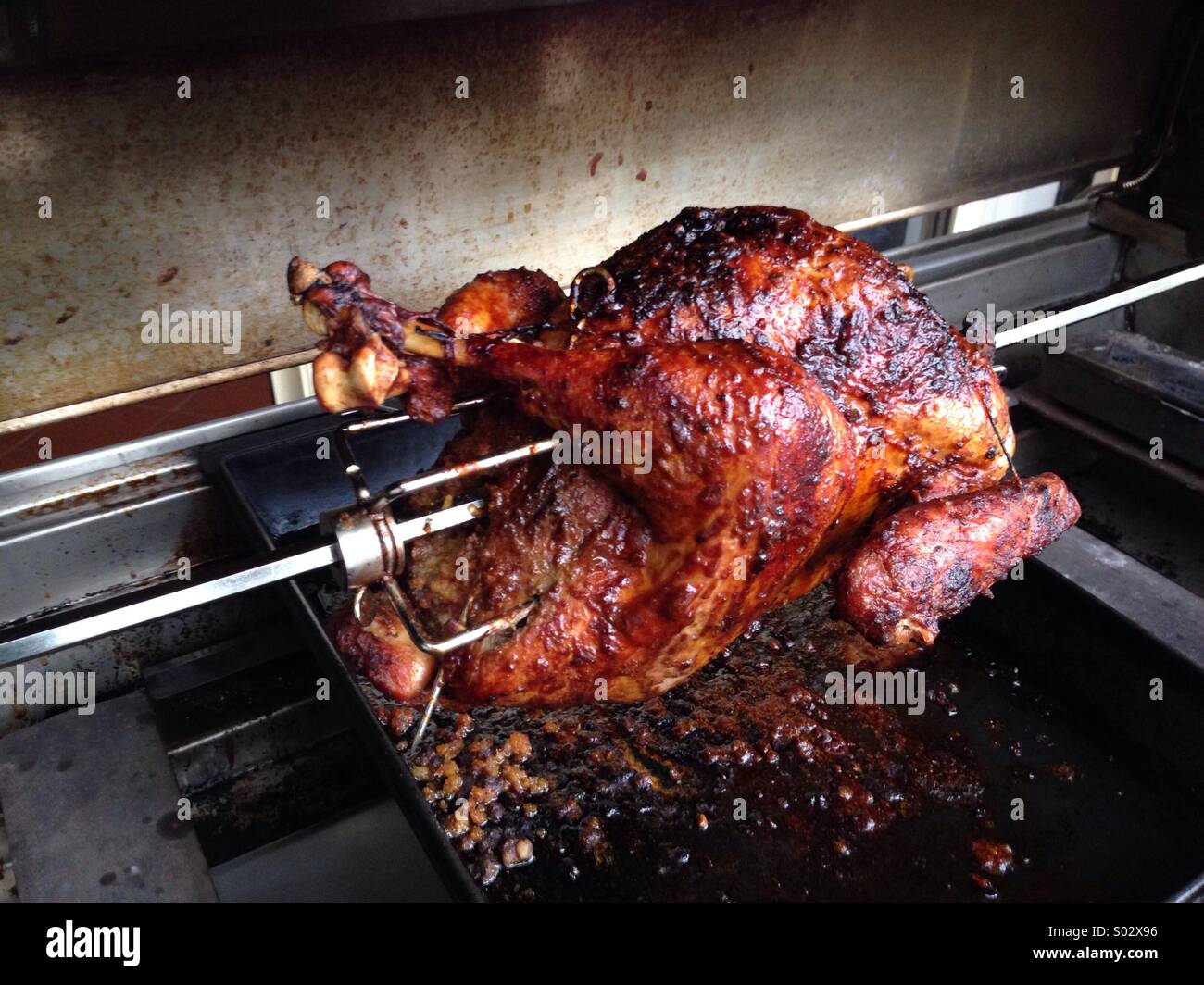 Turkey on a BBQ rotisserie Stock Photo Alamy