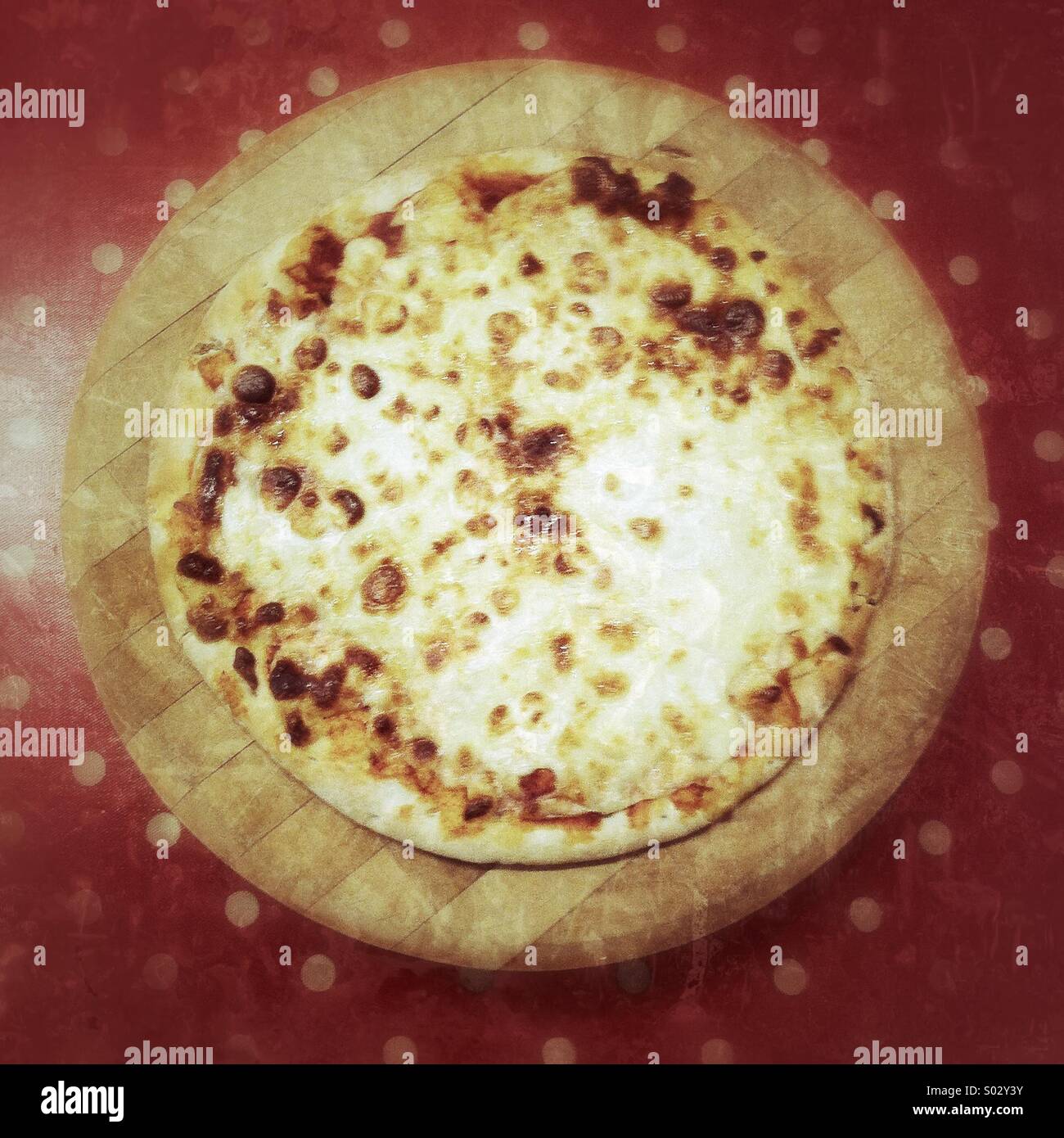 Margarita pizza on a wooden chopping board - Smartphone Captured Stock Image