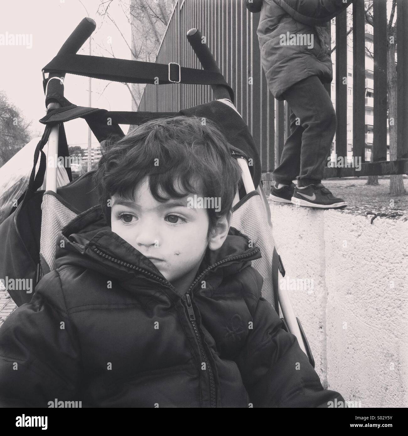 Two years old boy on his baby carriage Stock Photo