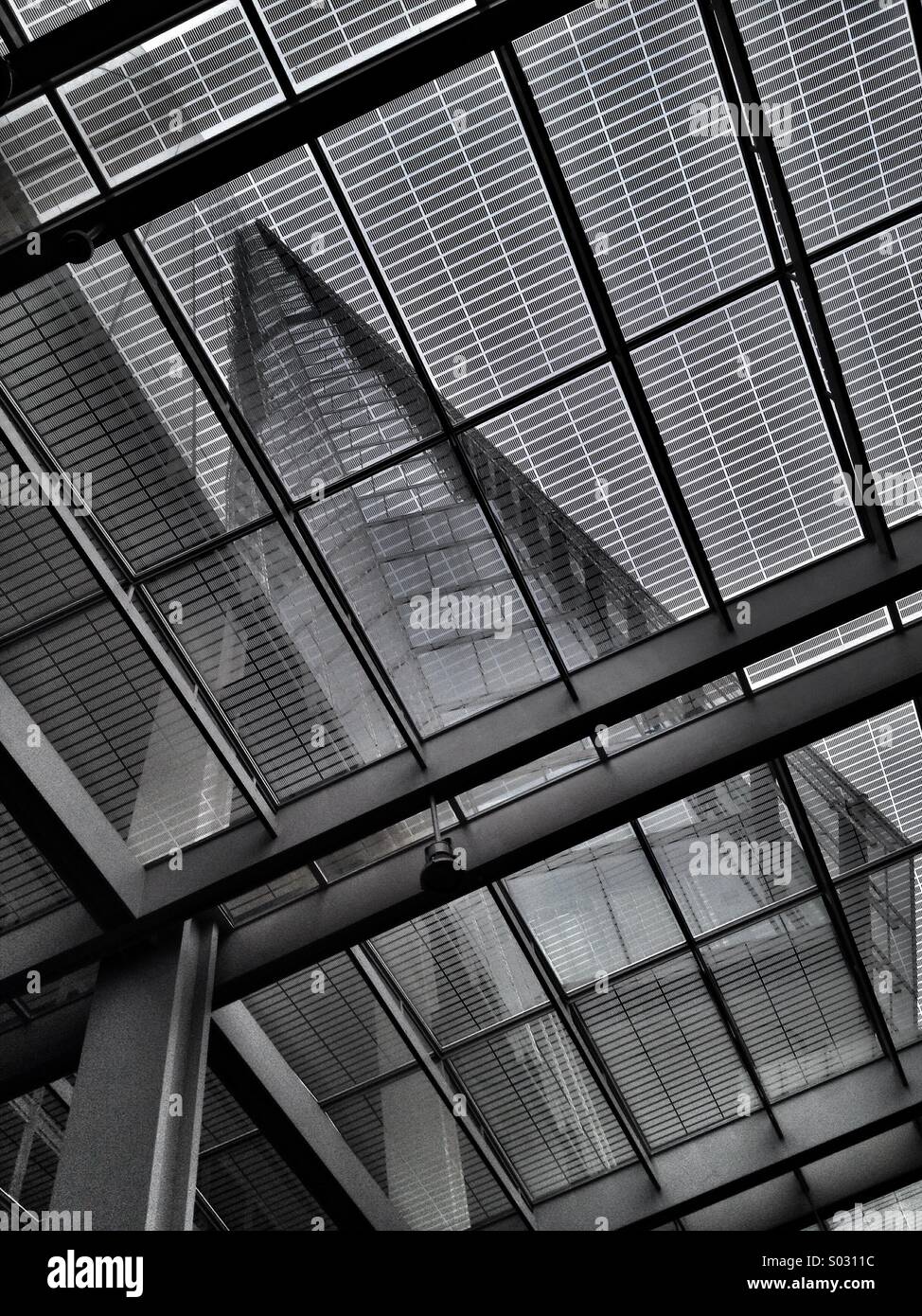 Abstract view of the Shard skyscraper through the glass roof of London Bridge railway station - Smartphone Captured Stock Image