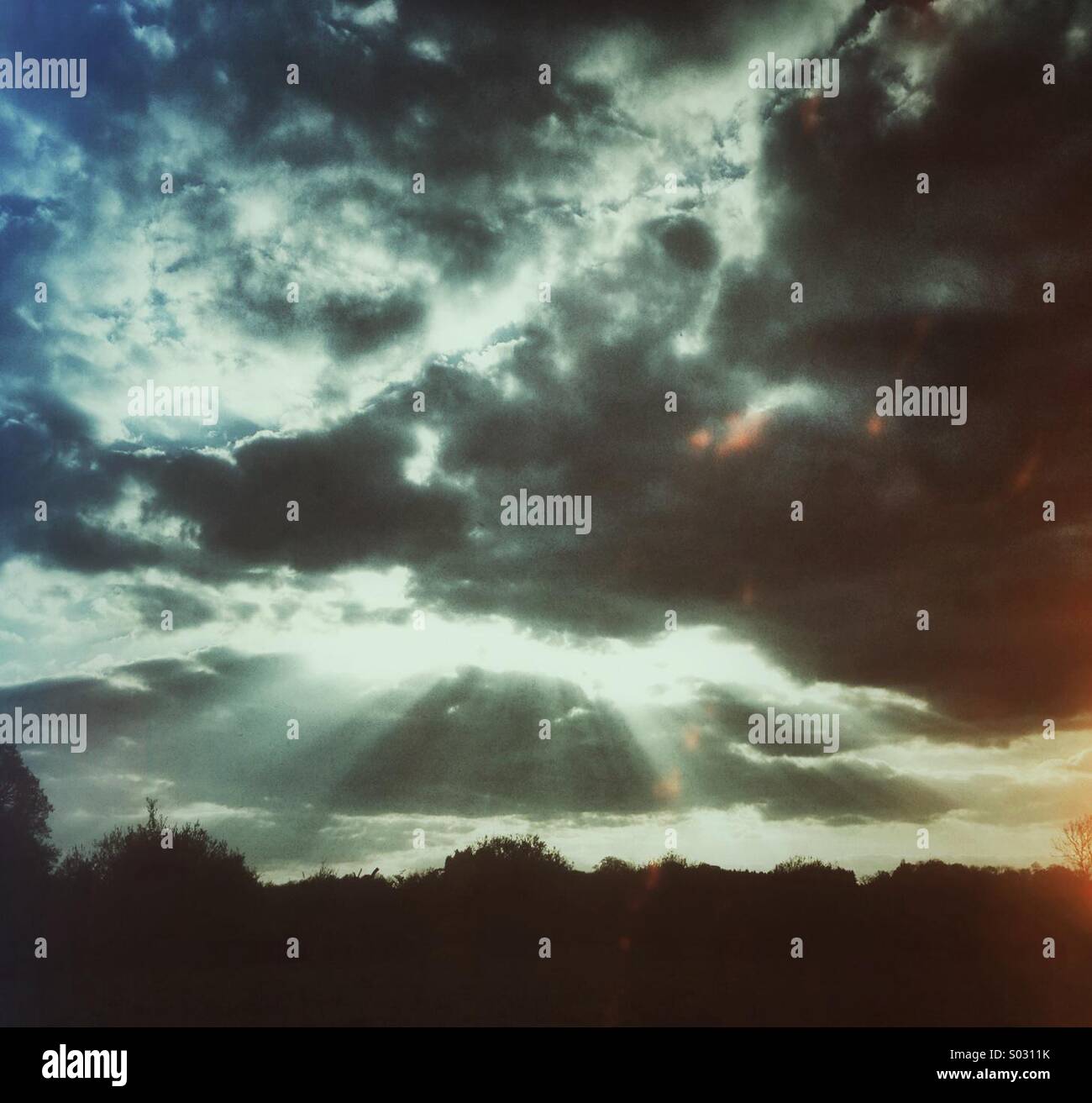 Dramatic sky showing crepuscular rays, UK - Smartphone Captured Stock Image