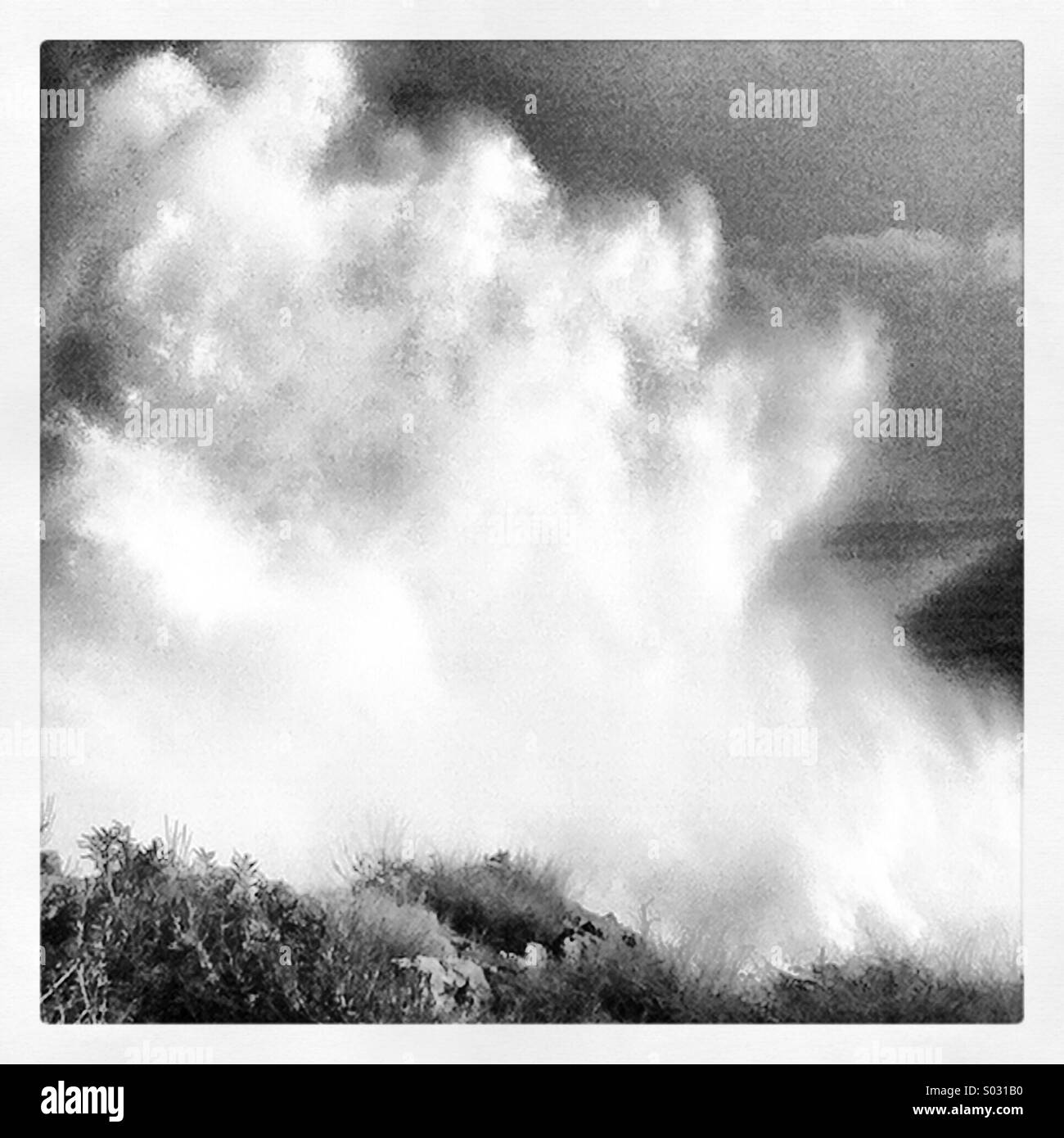 A wave hits the coastal area of Cascais during the ocean storms. Winter of 2014, Portugal. - Smartphone Captured Stock Image