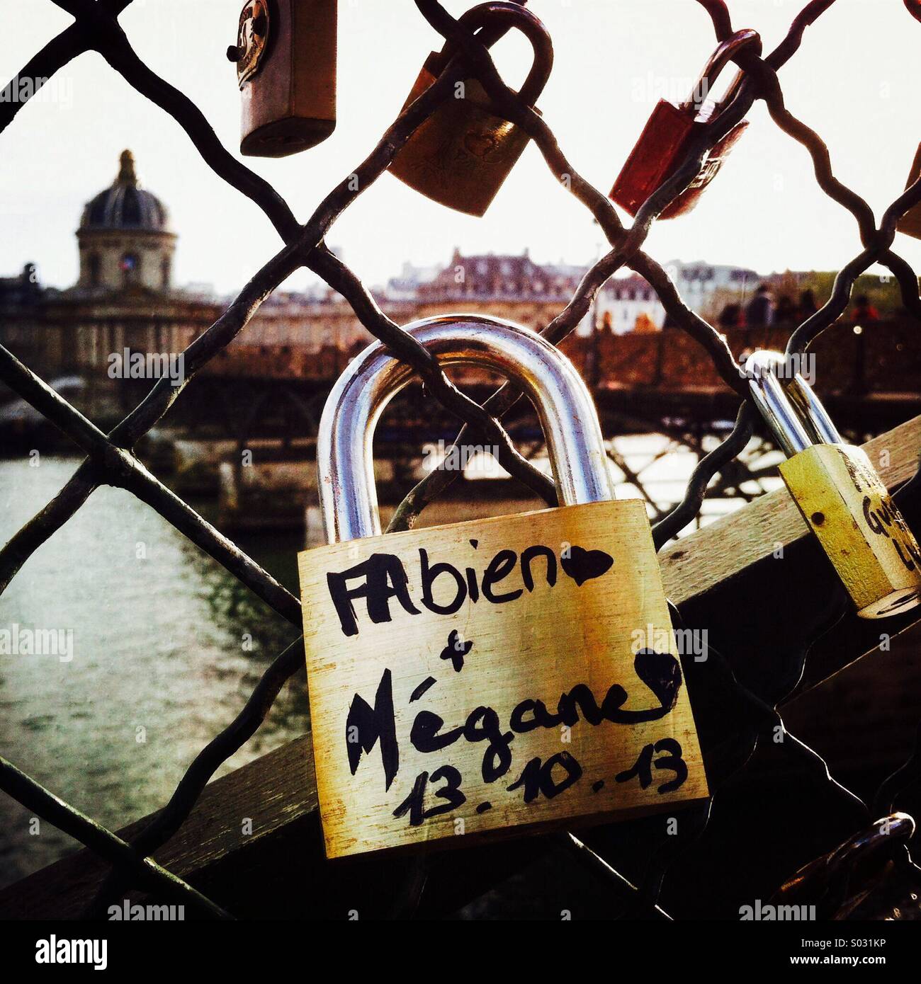 A love lock on the Pont des Arts bridge With the Institut de France in the background. - Smartphone Captured Stock Image