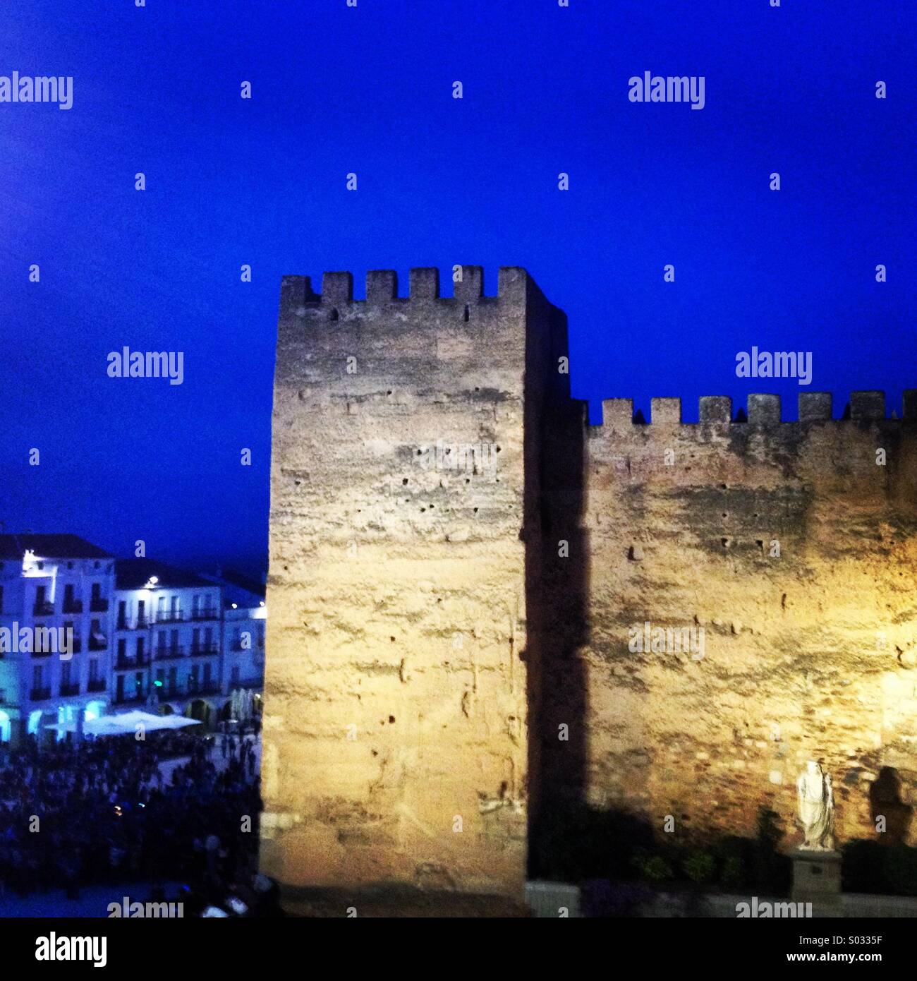 A tower of the city wall of Caceres fortress and the Plaza Mayor of Caceres, Extremadura, Spain - Smartphone Captured Stock Image