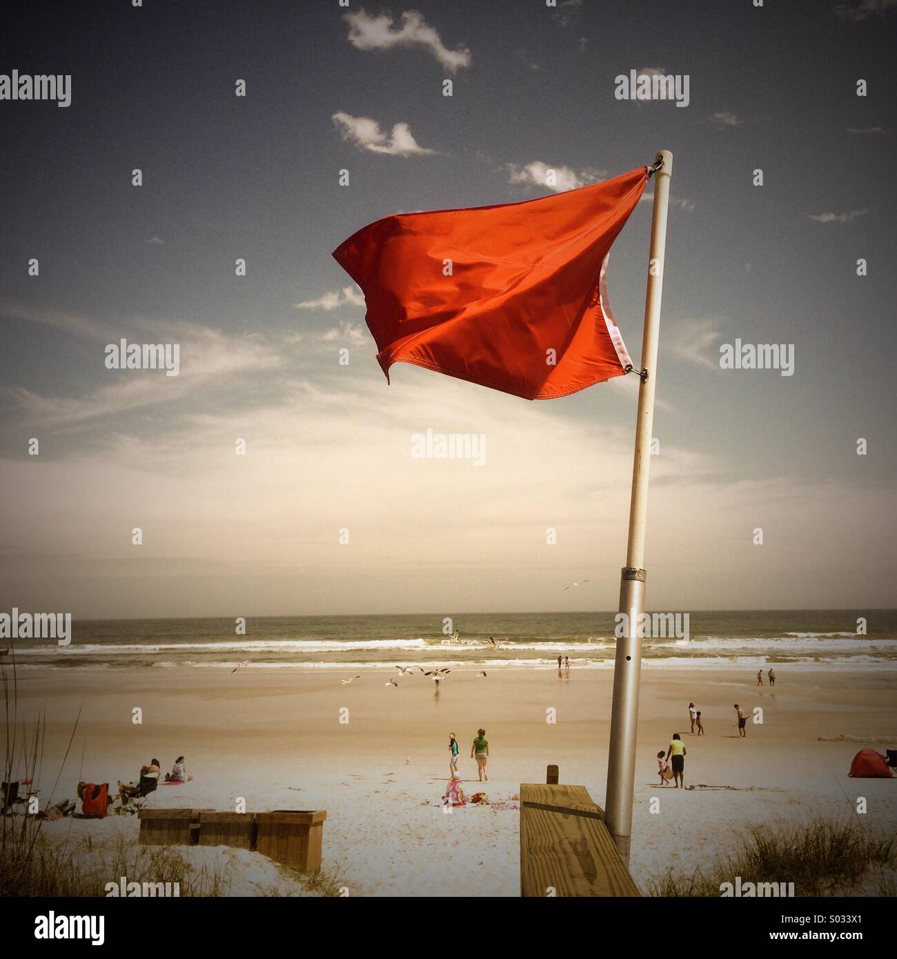 Red warning flag at Jacksonville Beach, Florida - Smartphone Captured Stock Image