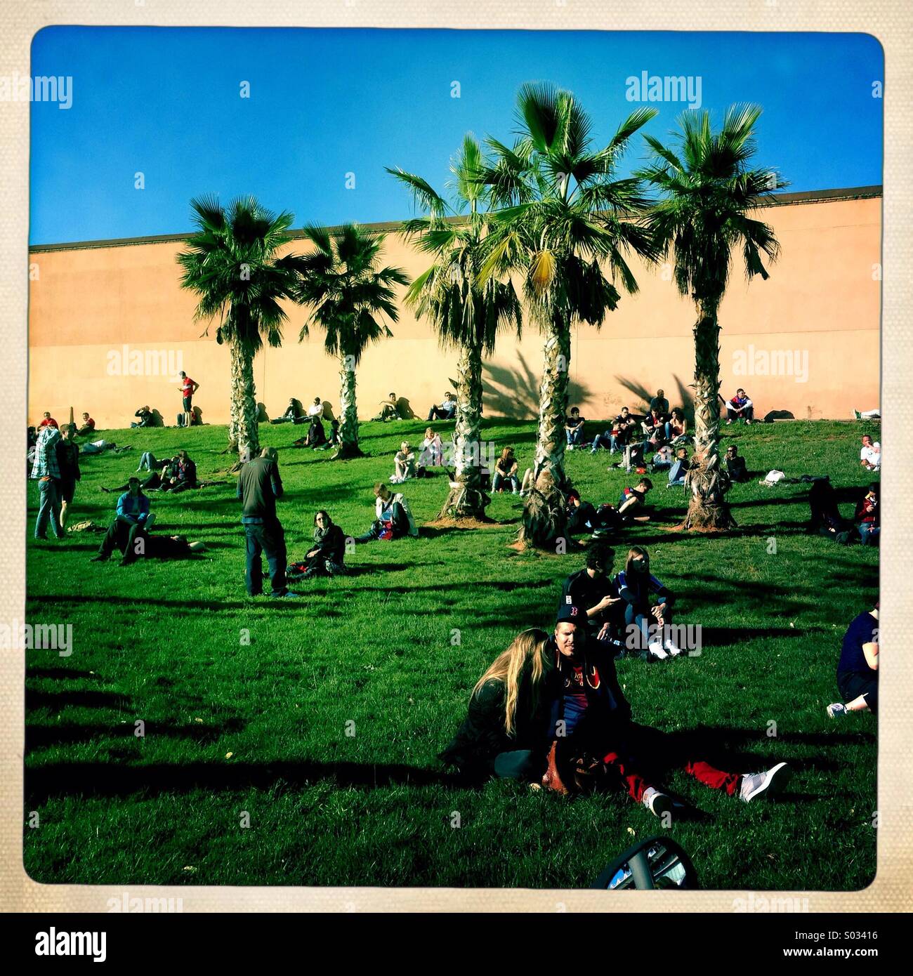 People relax in a park in Balcelona, Spain Stock Photo