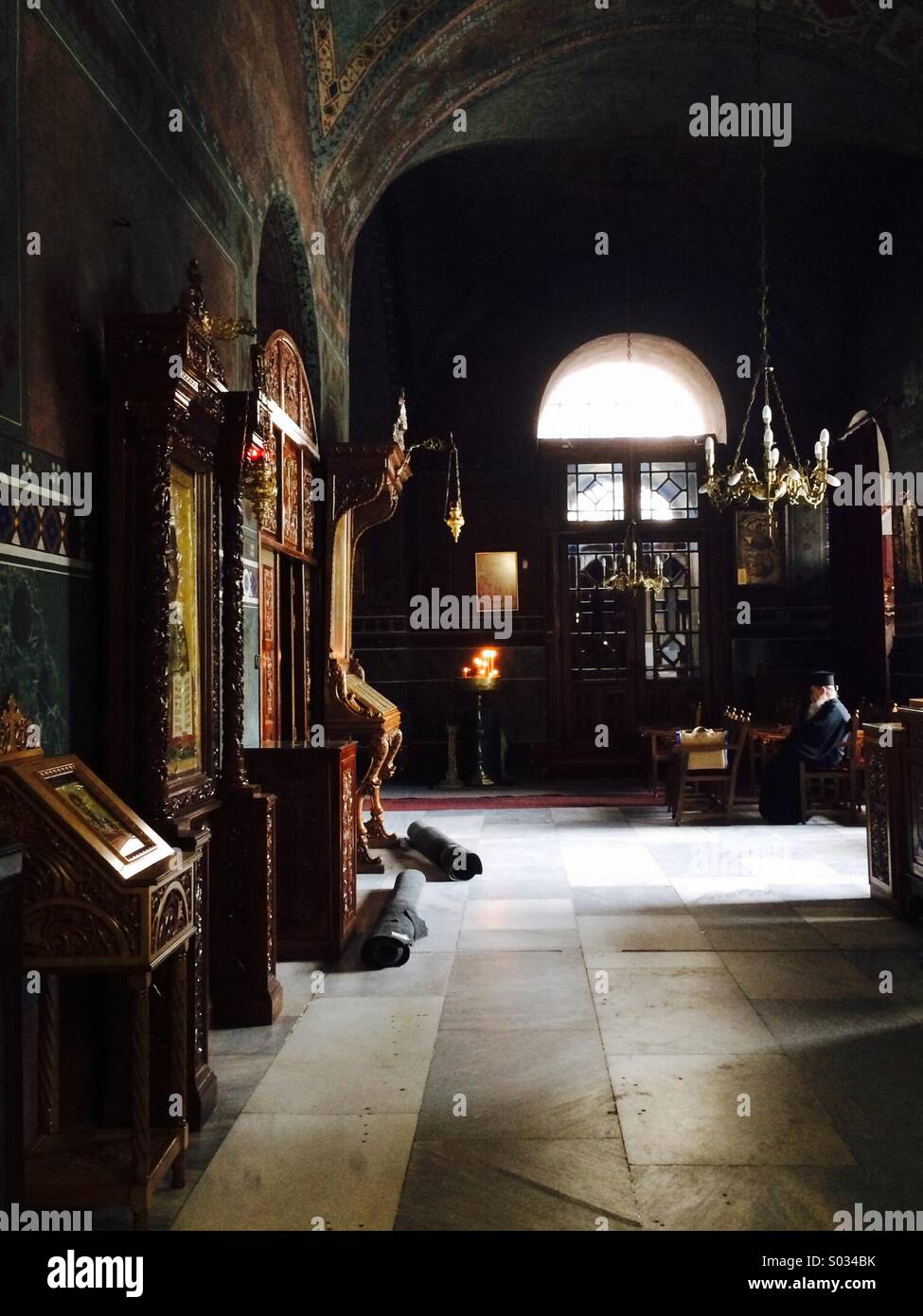 Greek Orthodox priest meditating in prayer at Agia Sofia, Stock Photo