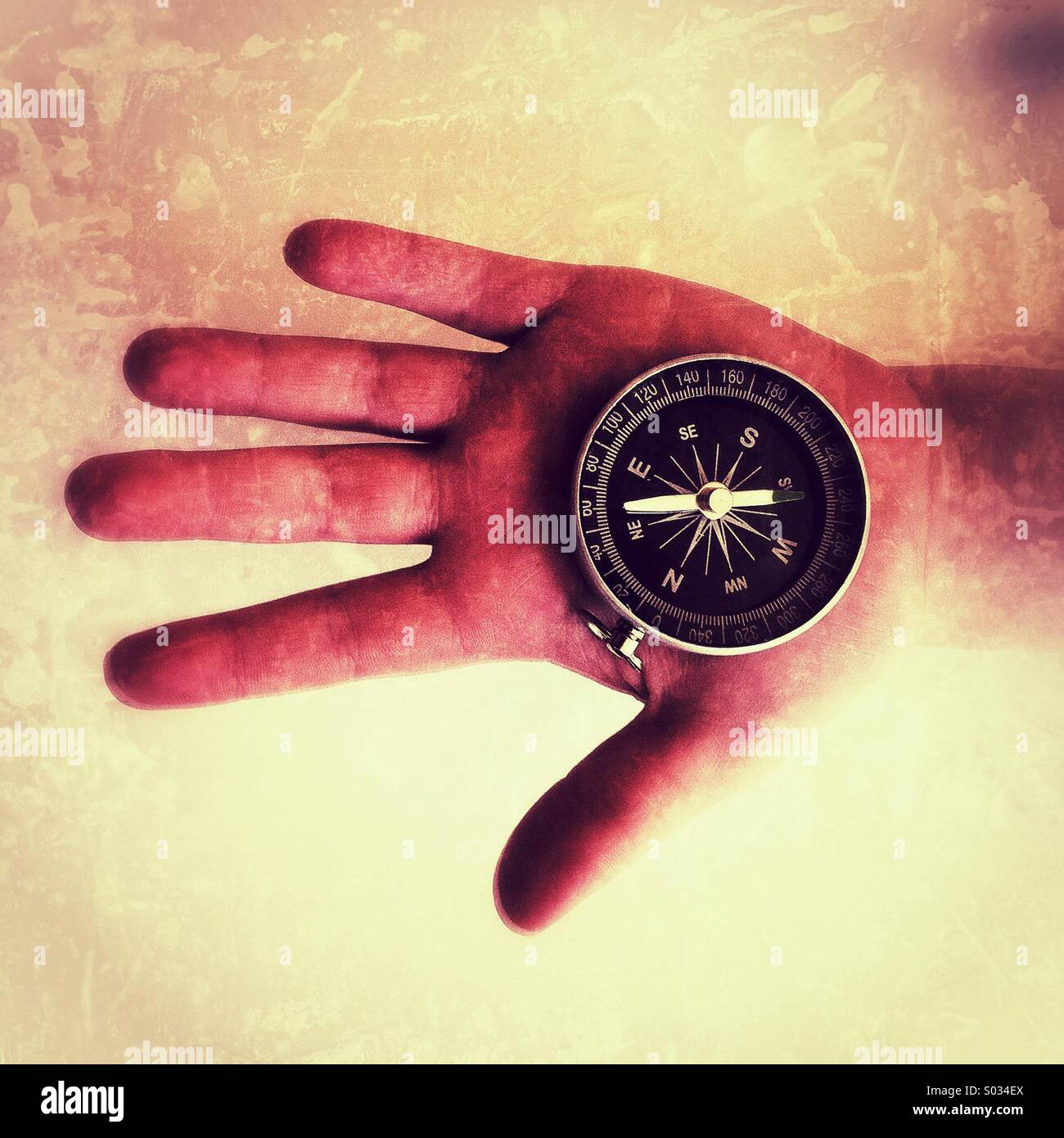 Magnetic compass in a boys hand - Smartphone Captured Stock Image