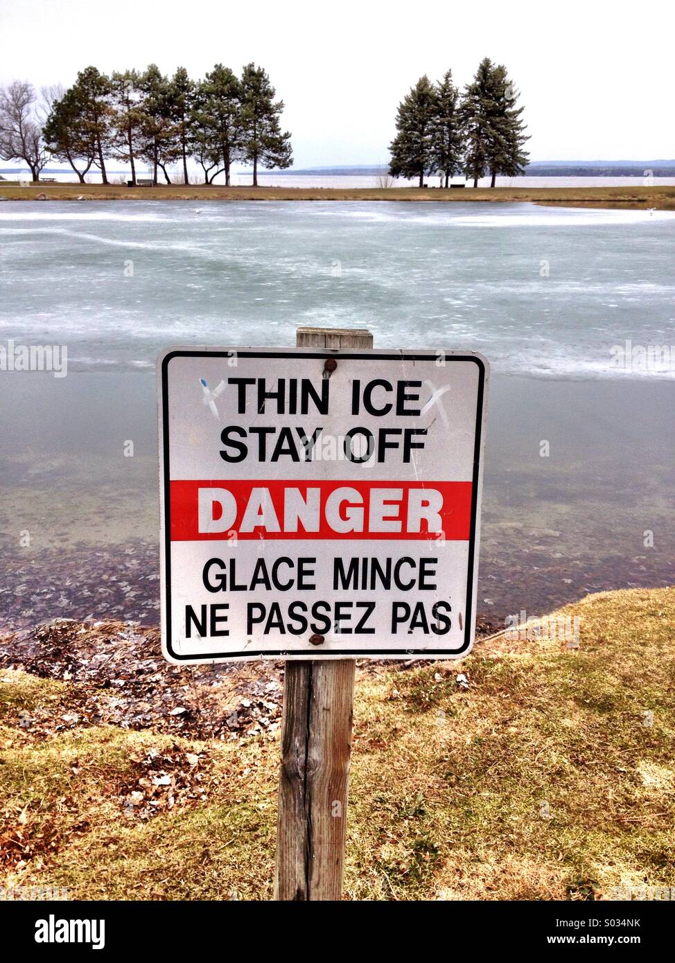 Thin Ice Warning Sign By A Pond In Canada Stock Photo