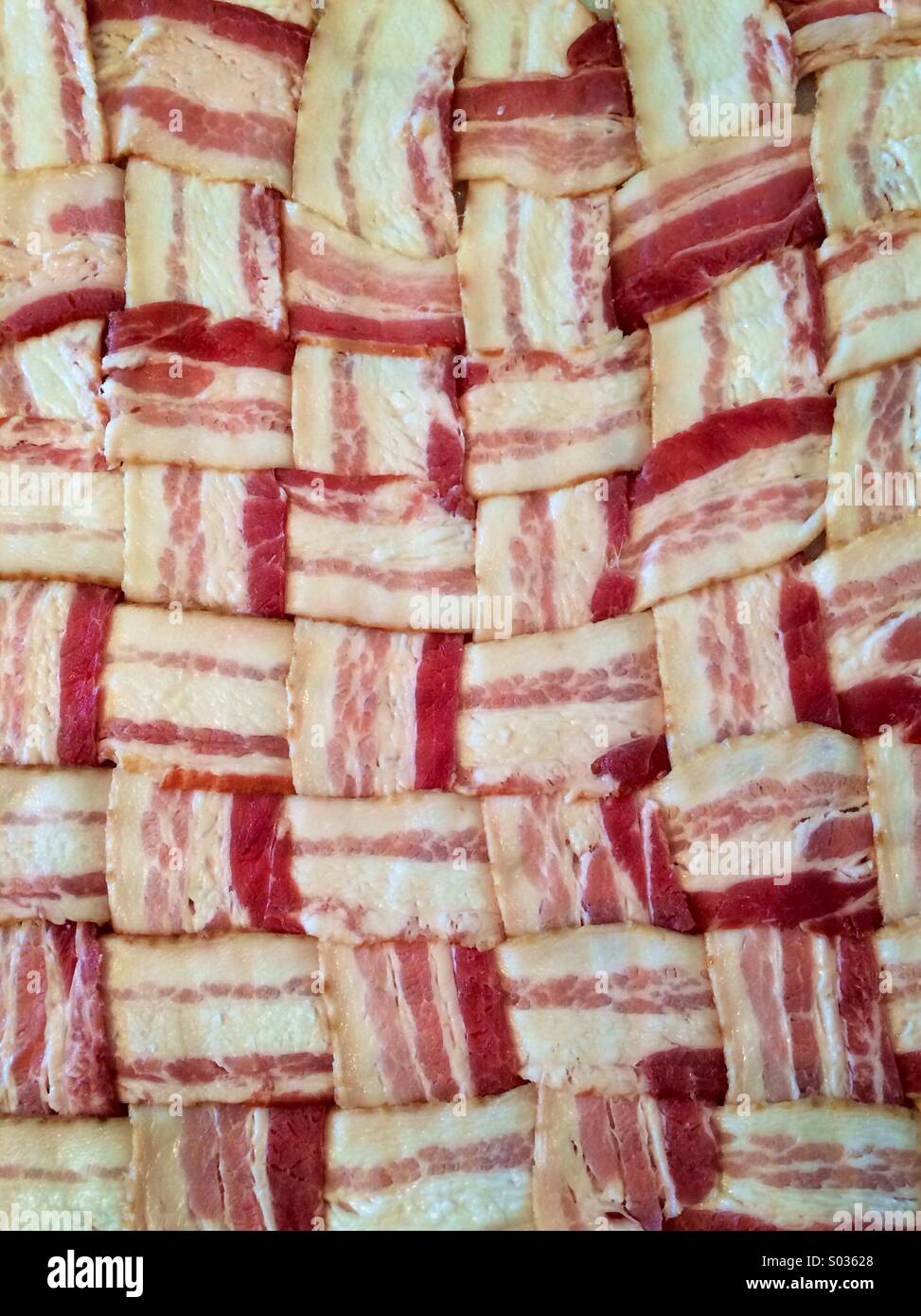 A woven bacon mat used for making a "fatty" in a smoker. - Smartphone Captured Stock Image