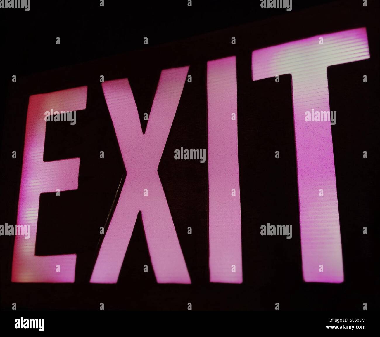 Pink Glowing Exit Sign over doorway in office building - Smartphone Captured Stock Image Pink Glowing Exit Sign over doorway in office building - Smartphone Captured Stock Image