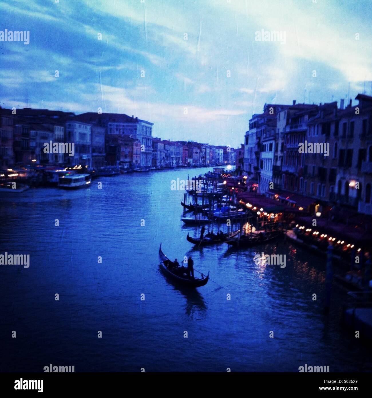 A gondola paddles down the grand canal. Venice Italy. Stock Photo