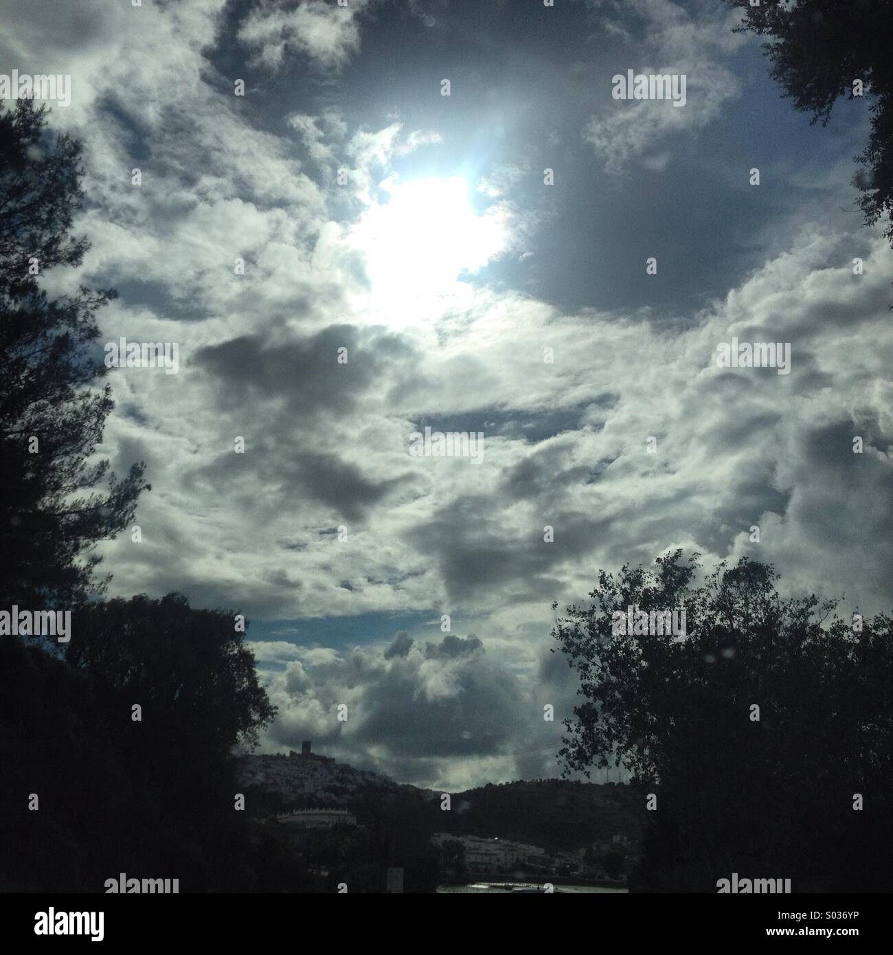 Sun shines behind the clouds after a storm in Arcos de la Frontera, Cadiz province, Andalusia, Spain - Smartphone Captured Stock Image