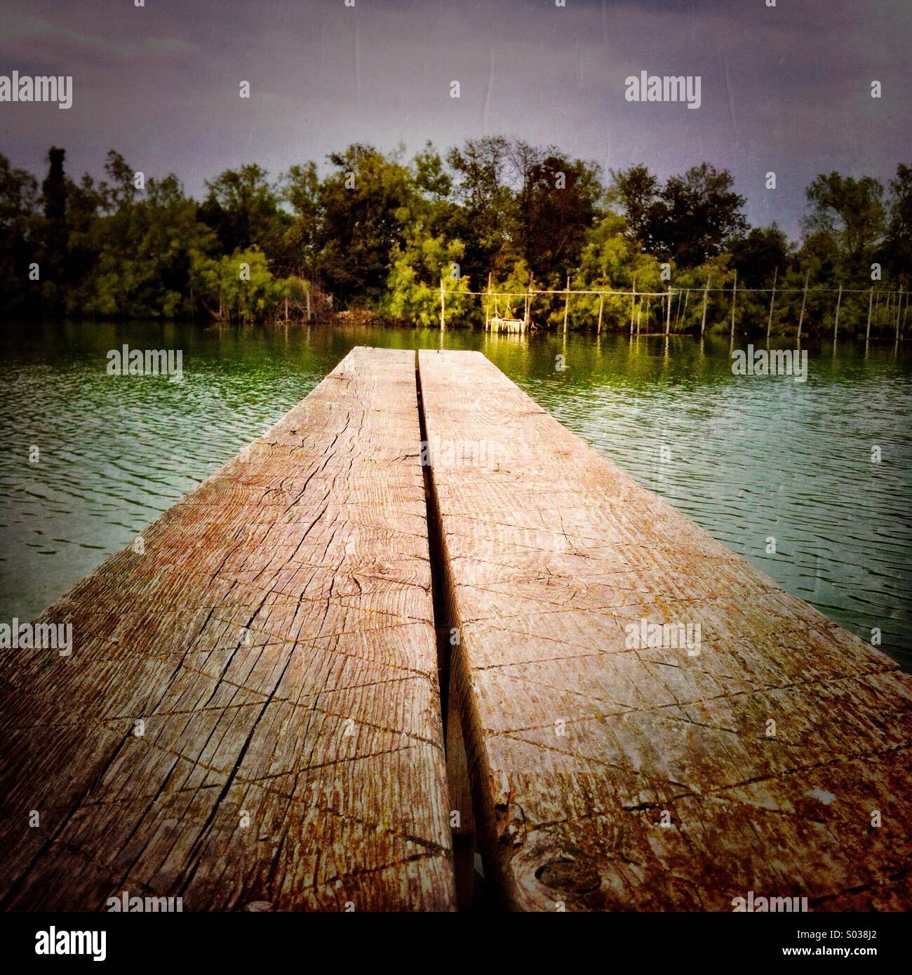 A wooded dock over a river. - Smartphone Captured Stock Image