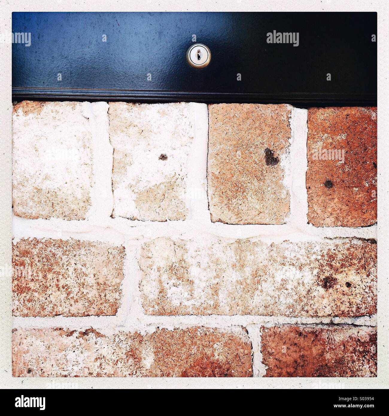 A lovely Letterbox on a red brick wall waiting for some snail mail Stock Photo