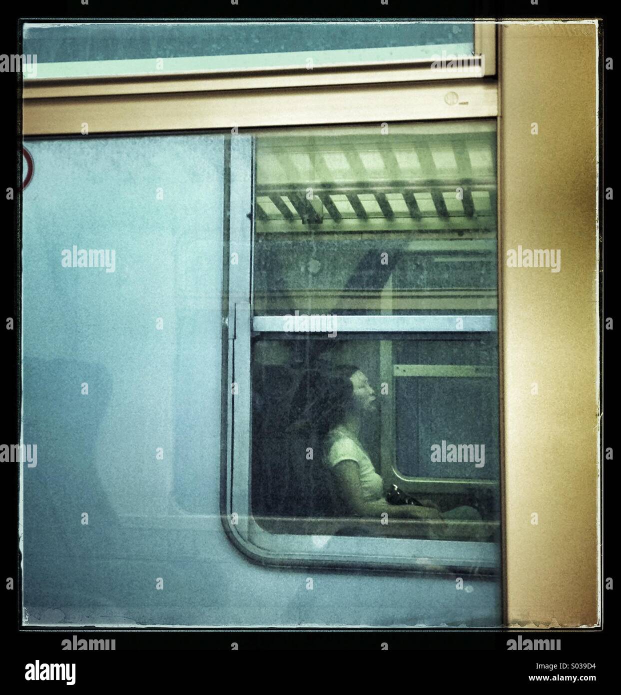 Oriental woman through the train windows Stock Photo