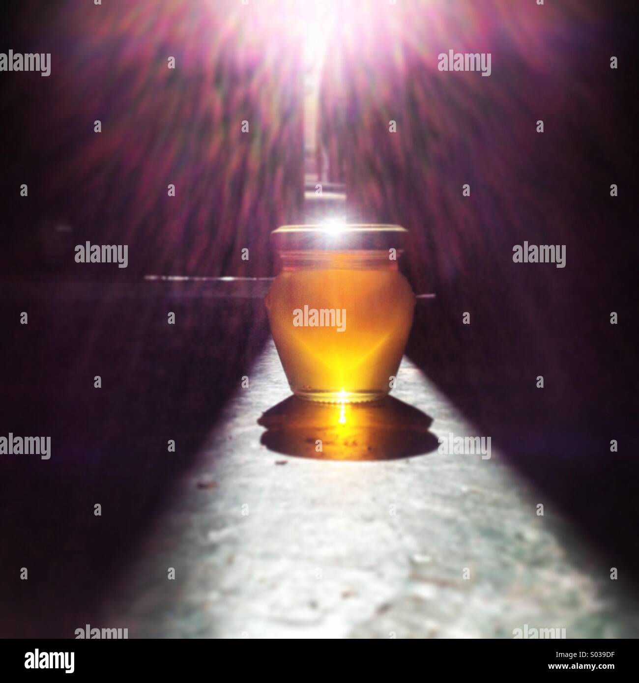 Sunlight shines over a honey pot in Puremiel factory, Prado del Rey, Cadiz province, Andalusia, Spain - Smartphone Captured Stock Image Sunlight shines over a honey pot in Puremiel factory, Prado del Rey, Cadiz province, Andalusia, Spain - Smartphone Captured Stock Image