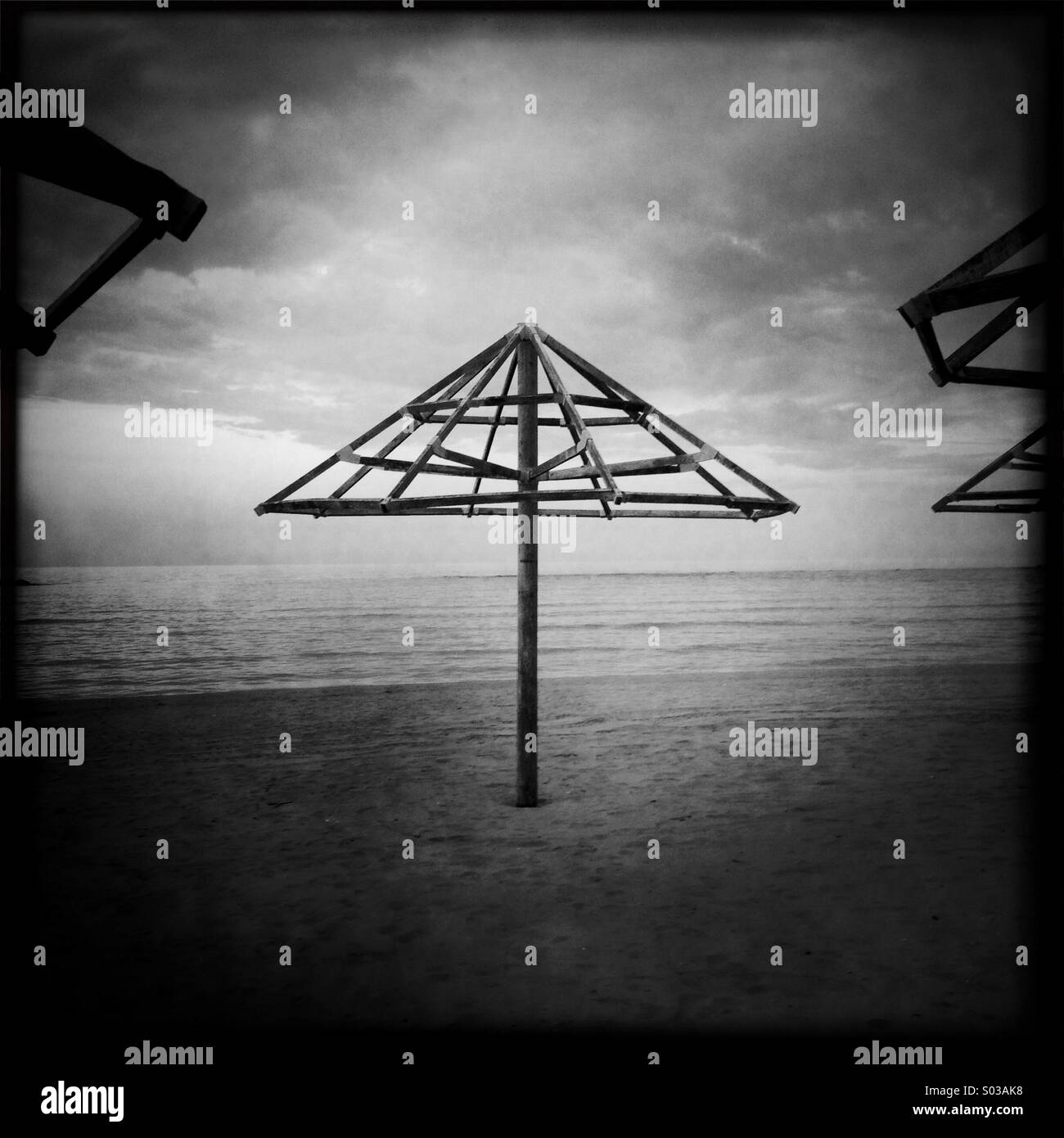 Surreal landscape abstract composition big beach umbrella structure arrow shape triangle concept - Smartphone Captured Stock Image