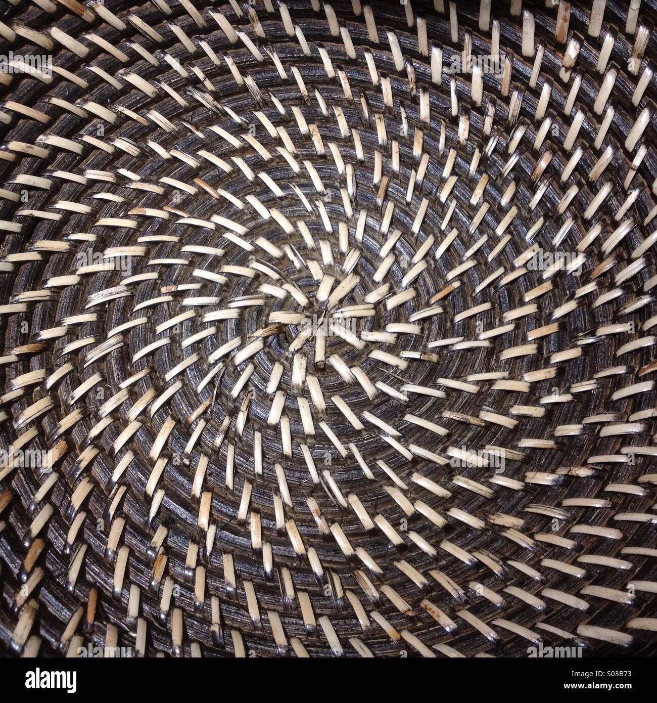 Center of woven table mat with both spiral and radial symmetry Stock Photo