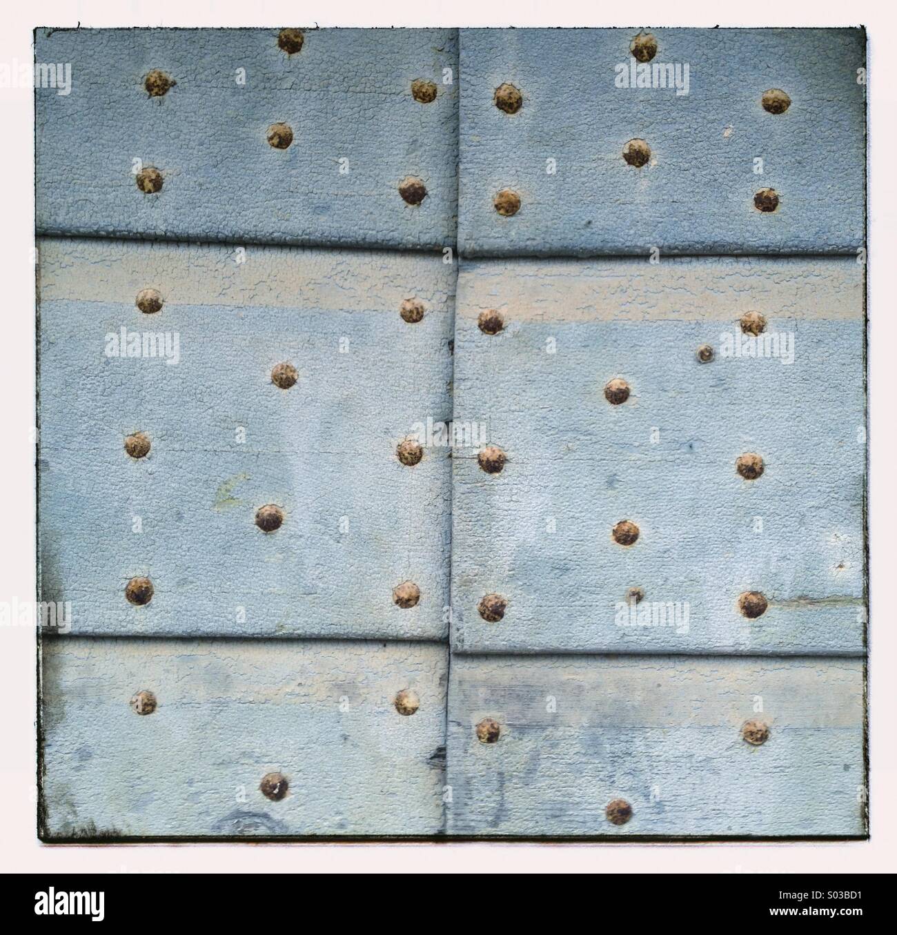 Old blue door dotted with nails - Smartphone Captured Stock Image