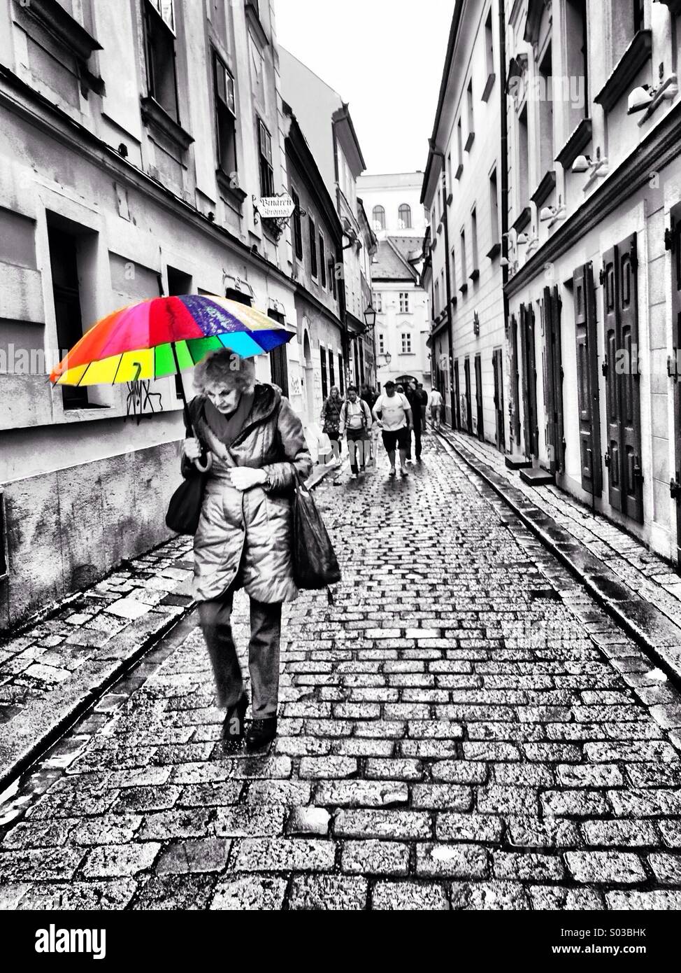 Lady in rain with multicolored umbrella - Smartphone Captured Stock Image