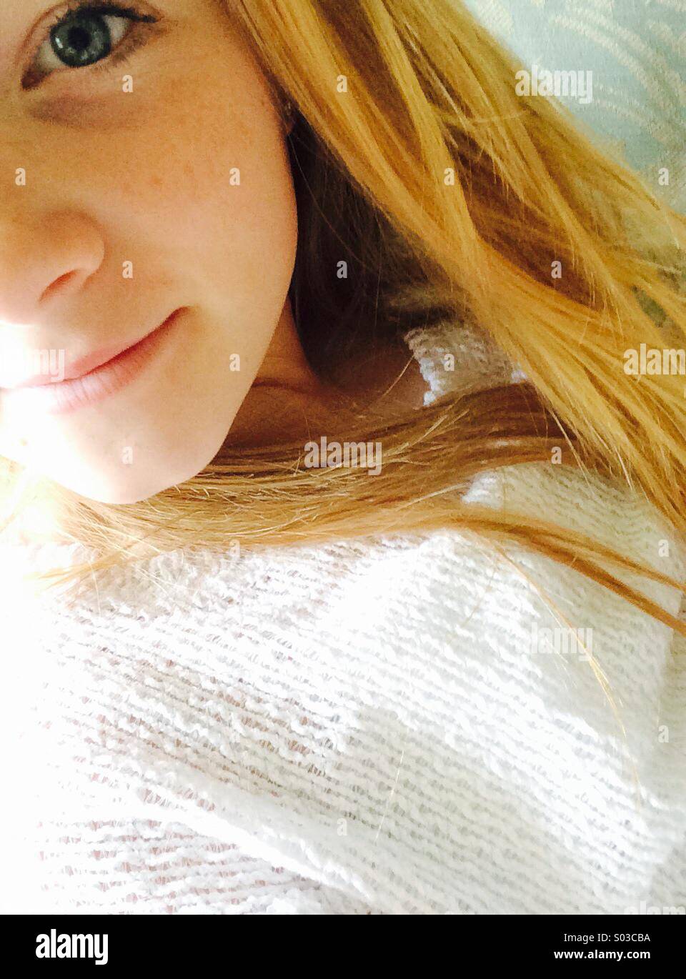 Teenage red headed young person on close-up - Smartphone Captured Stock Image