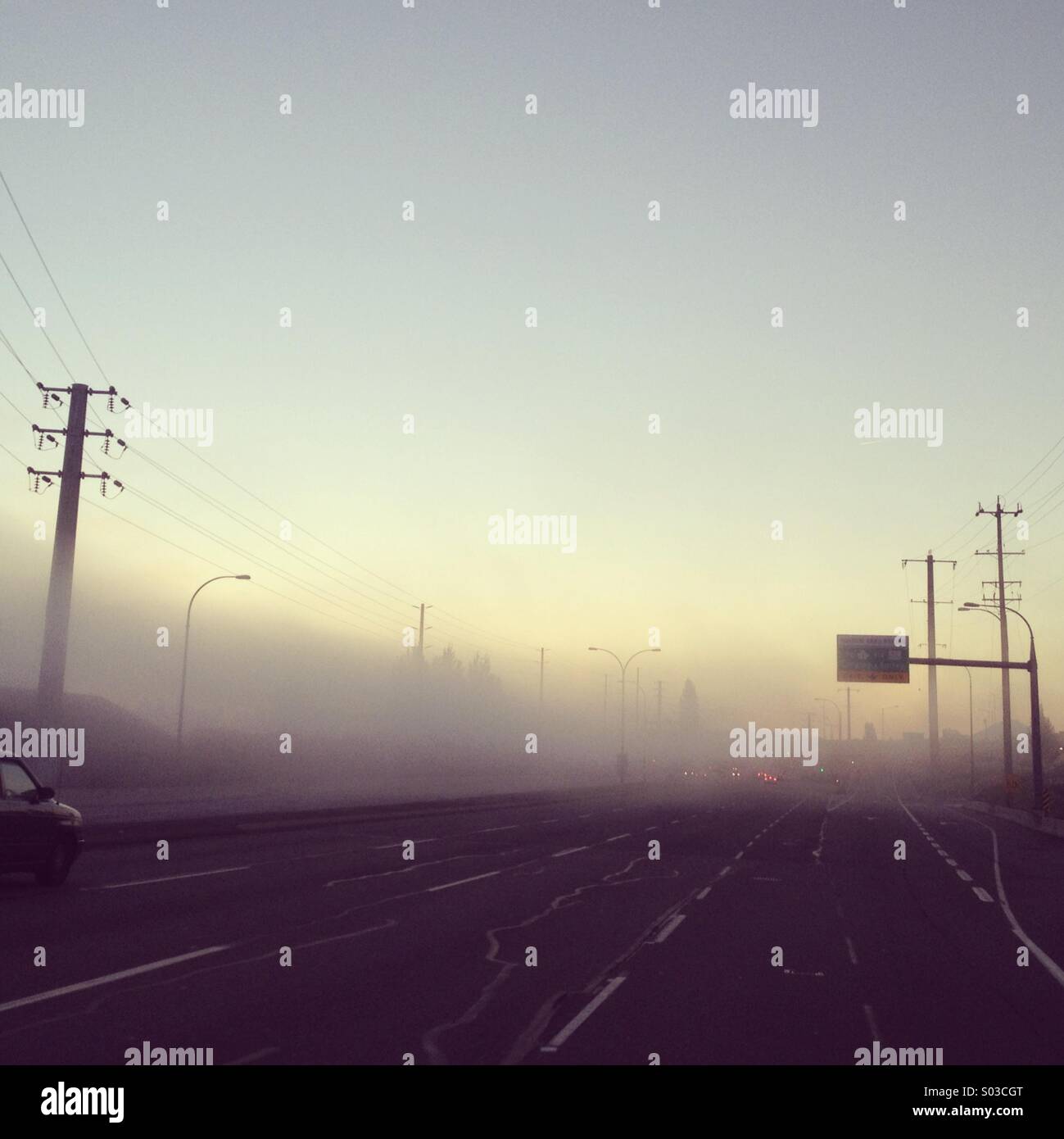 Early morning highway drive into the fog. - Smartphone Captured Stock Image