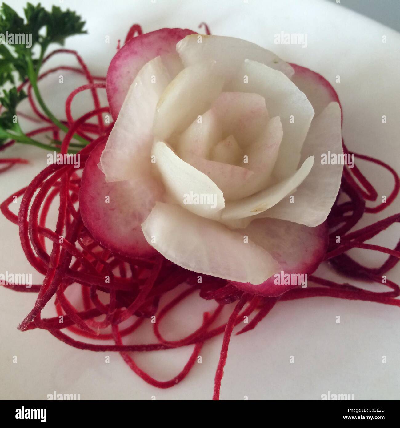 Radish rose garnish with parsley Stock Photo