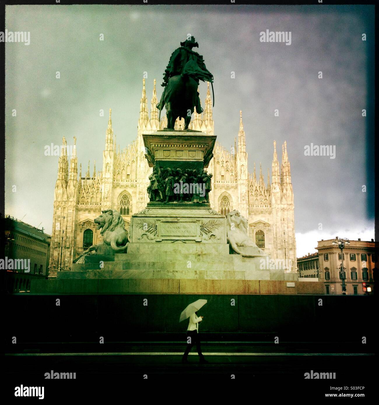 Milan Italy Duomo square statue under rain rainy day white umbrella walking under statue woman tourist - Smartphone Captured Stock Image