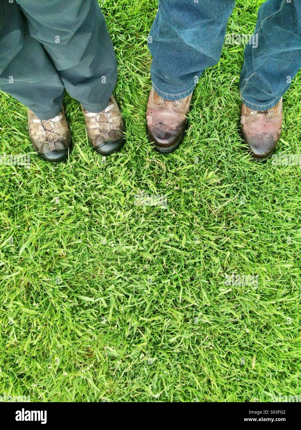 Walker's legs and boots on grass. - Smartphone Captured Stock Image