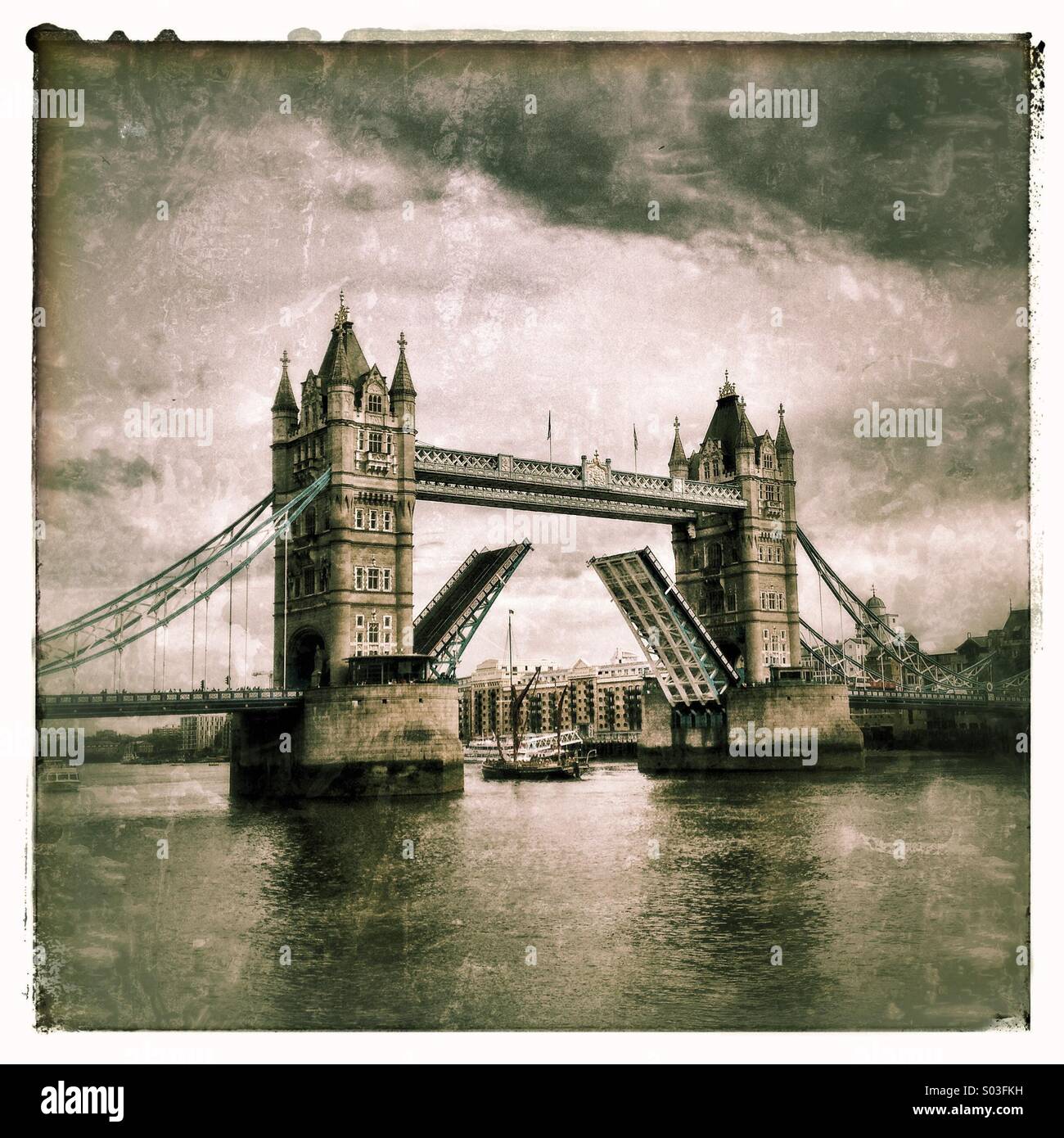 Tower Bridge on River Thames in London UK opening to let tall ship pass through - Smartphone Captured Stock Image