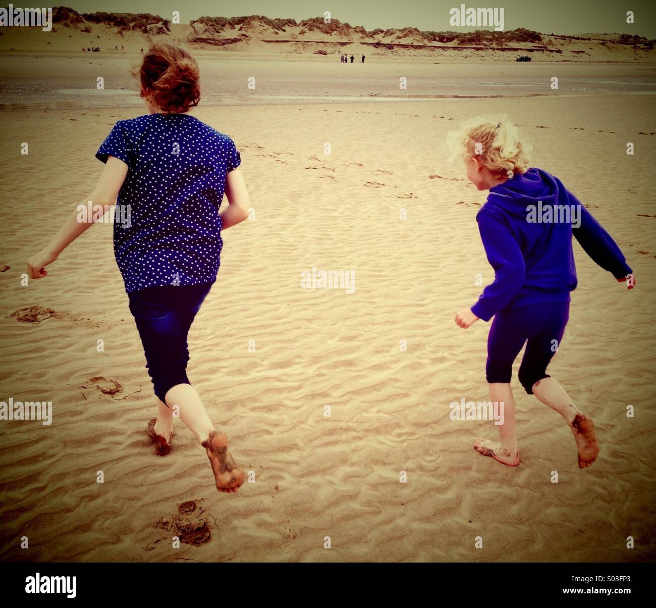 Two girls running on beach Stock Photo Alamy