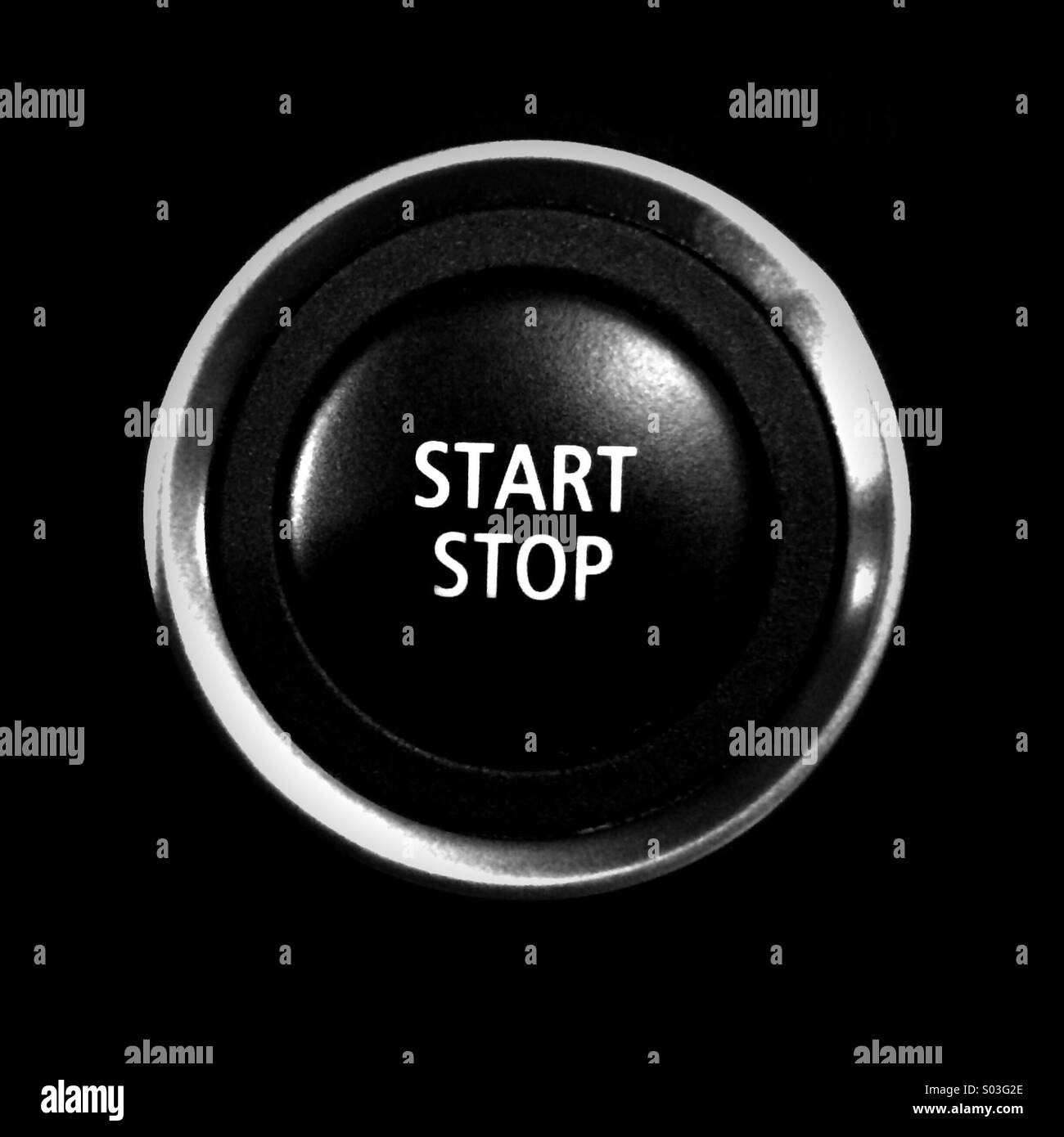 A start/stop engine button on the dashboard of a car Stock Photo