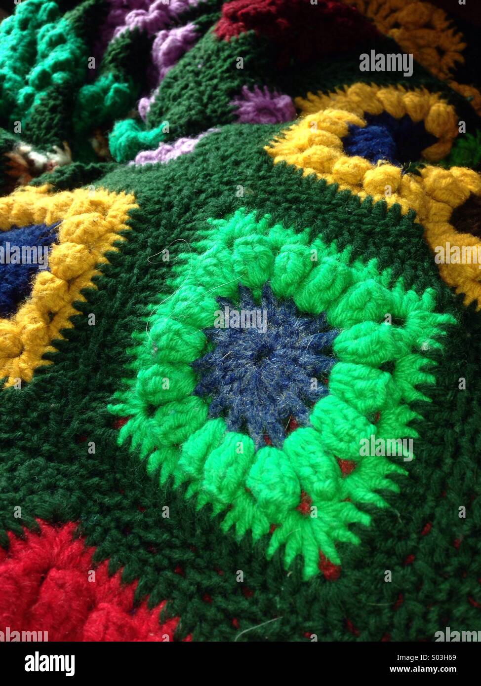 The details are crocheted with their own hands, multicolored yarn lies on a  wooden table Stock Photo by Yashik7777