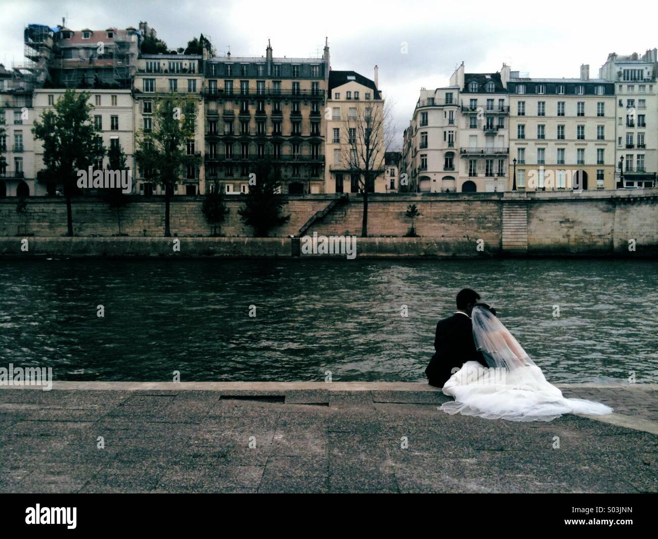 Bride and groom by the Seine in Paris. - Smartphone Captured Stock Image