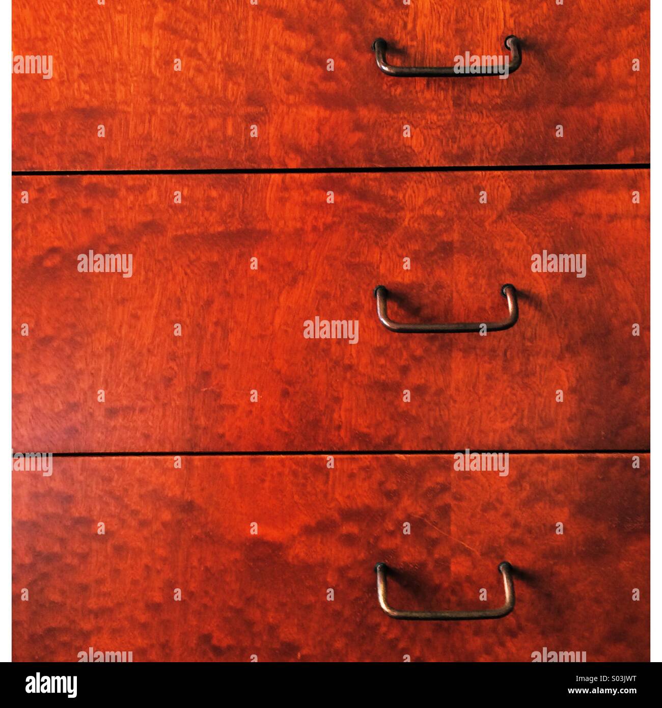 Wood grain pattern and handles on original 1960's chest of drawers - Smartphone Captured Stock Image