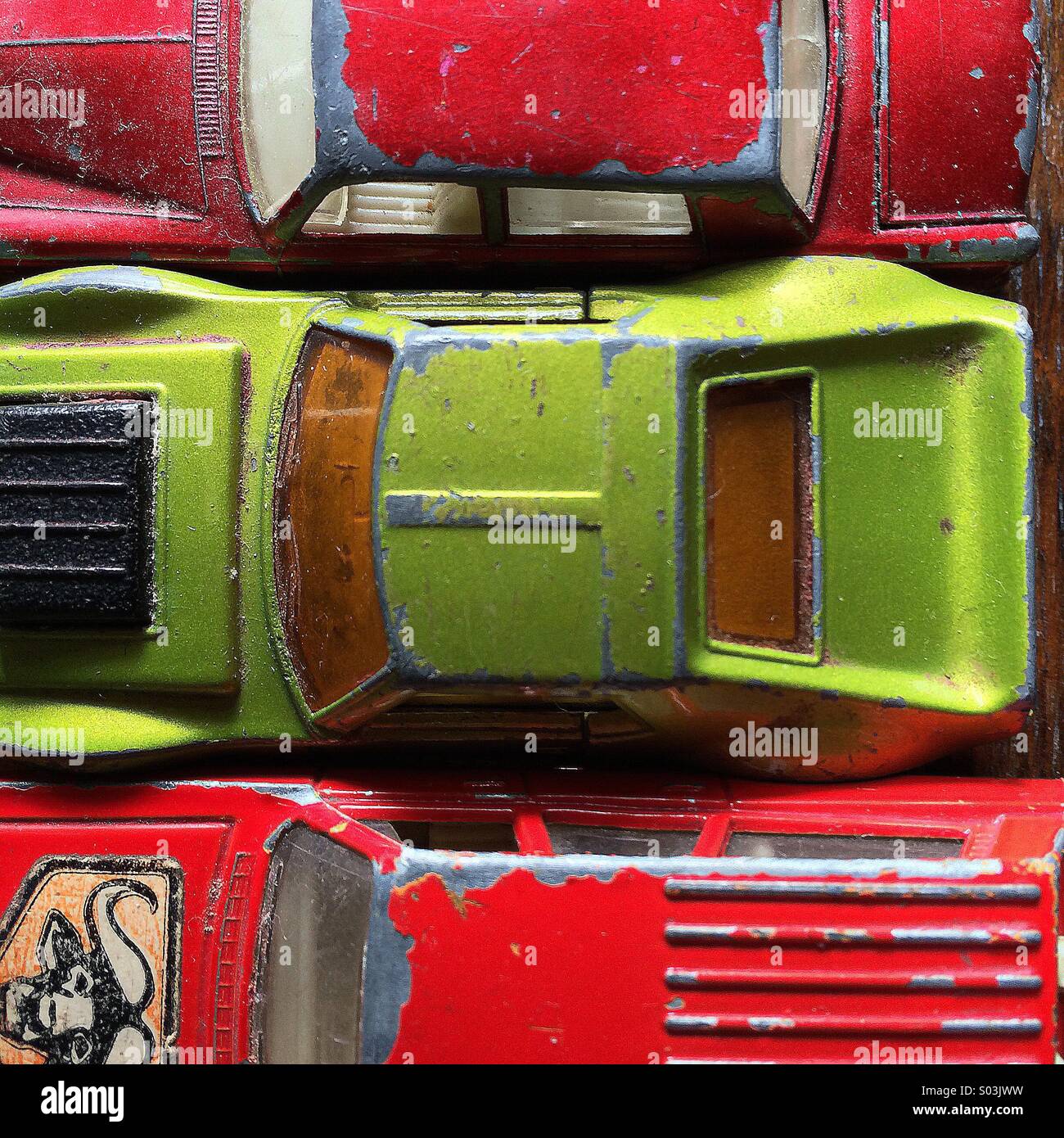 Three 1960's scratched and aged toy cars Stock Photo