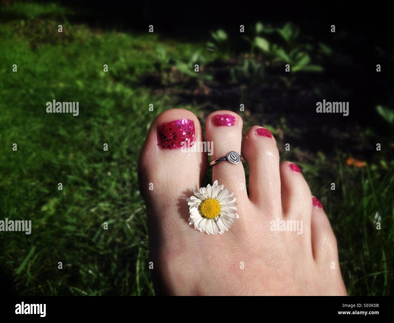 Pretty foot with daisy Stock Photo