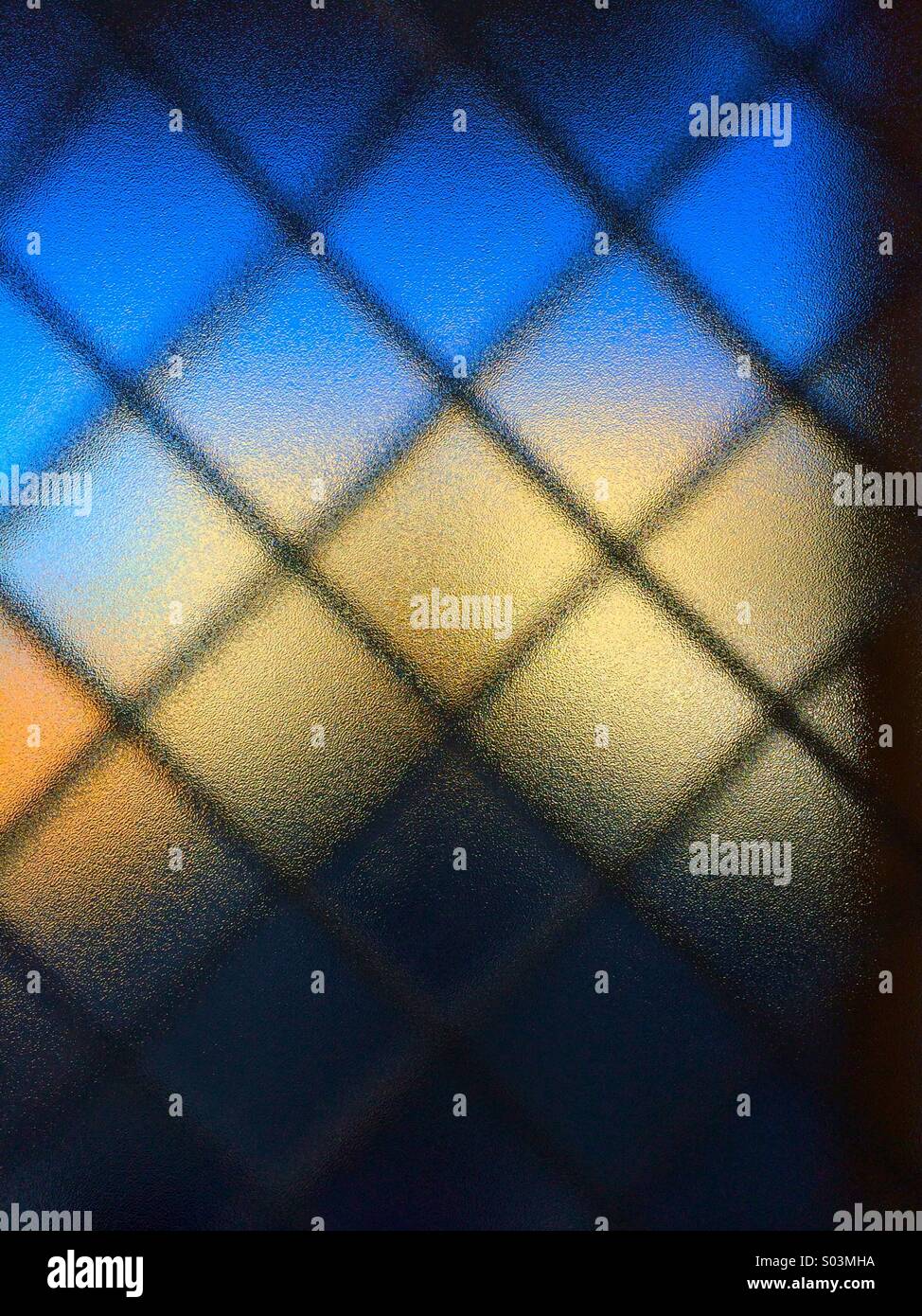 Window with frosted glass and wire pattern. Stock Photo