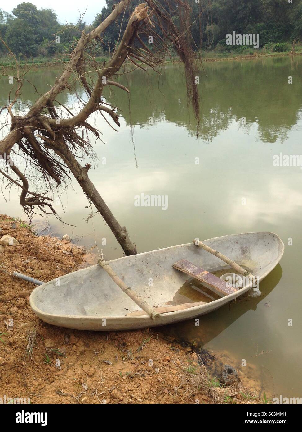 Small fishing boat on a lake side Stock Photo