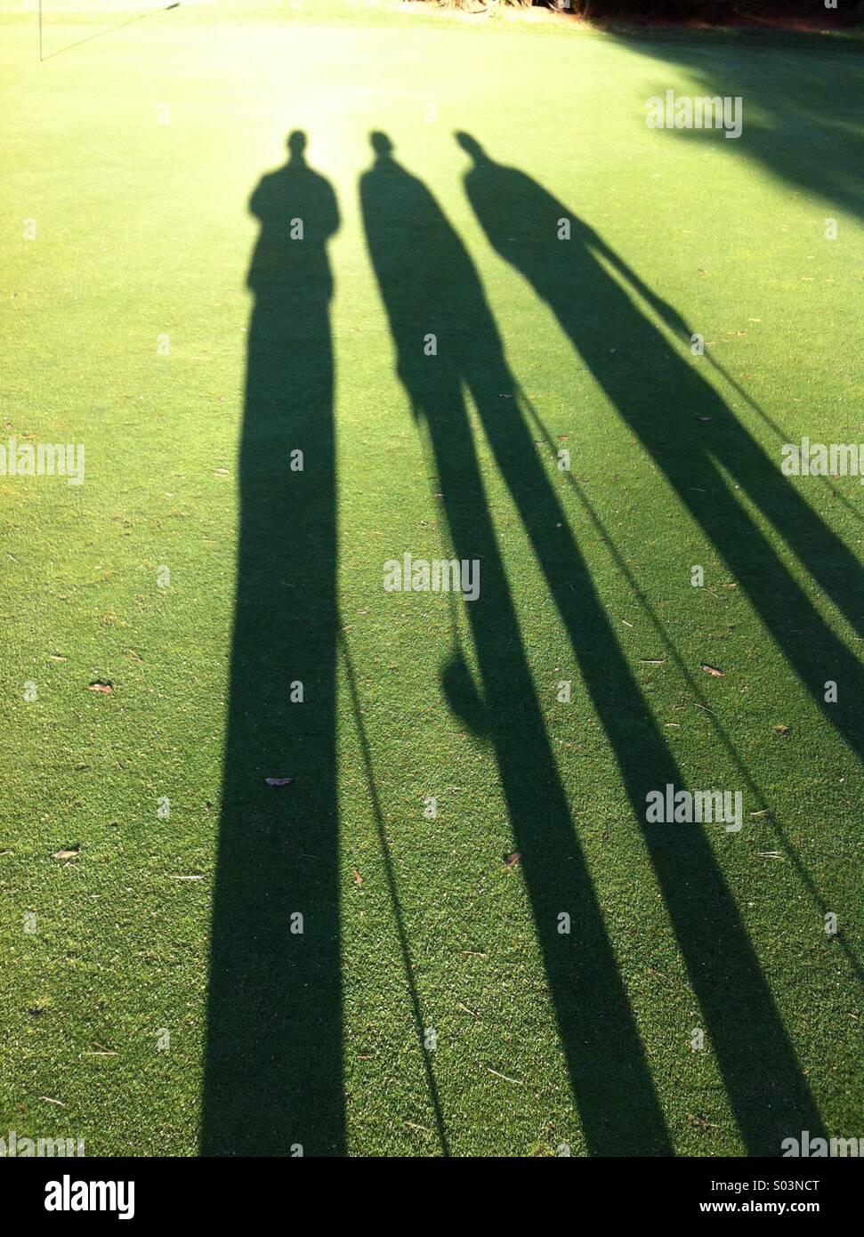 Golfers shadows Stock Photo