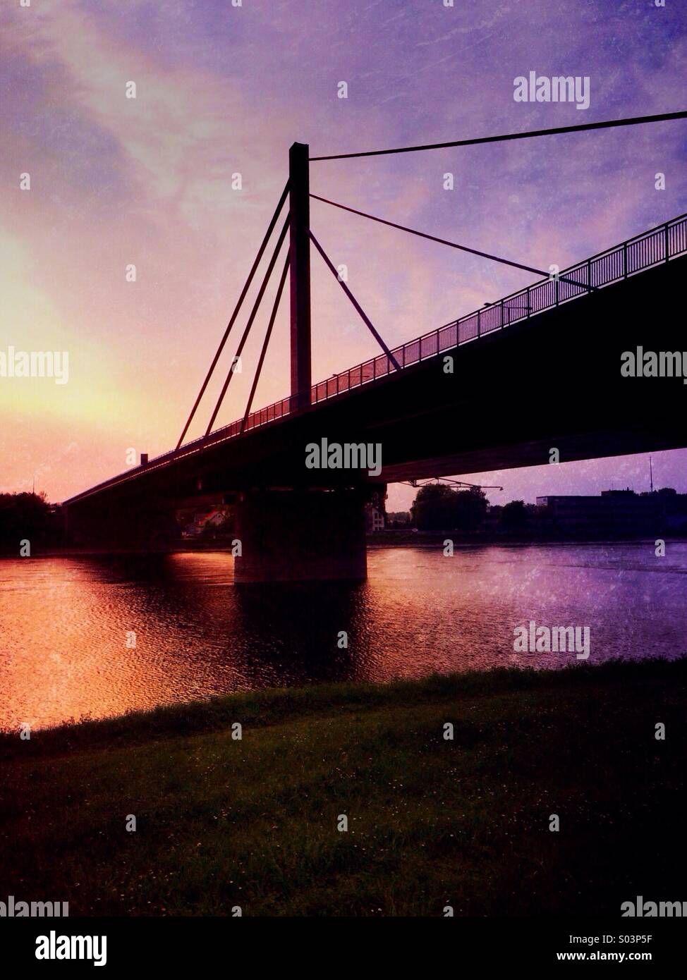 Road Bridge over the River Rhine at Sunset Stock Photo