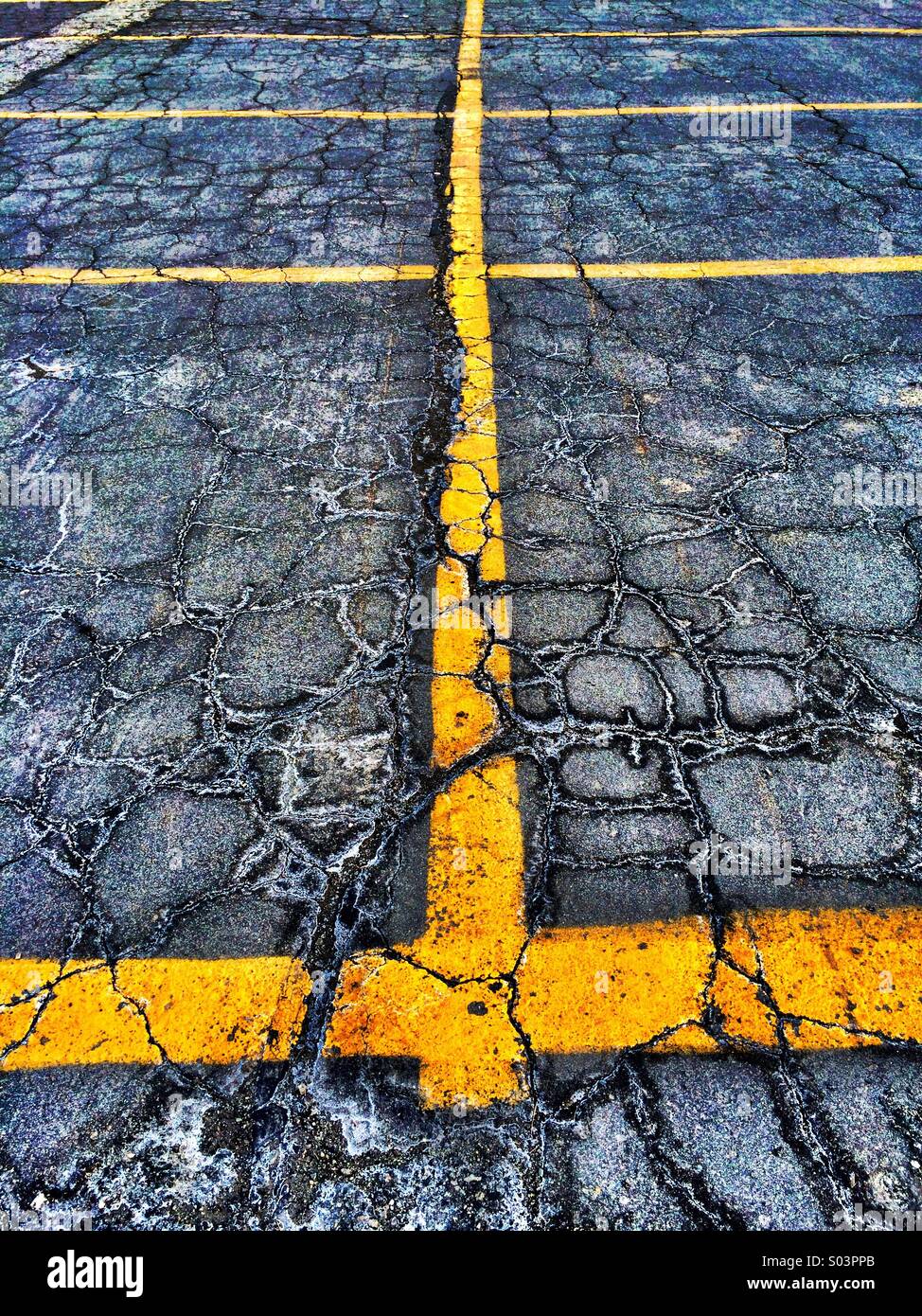Yellow line painted on cracked pavement Stock Photo Alamy