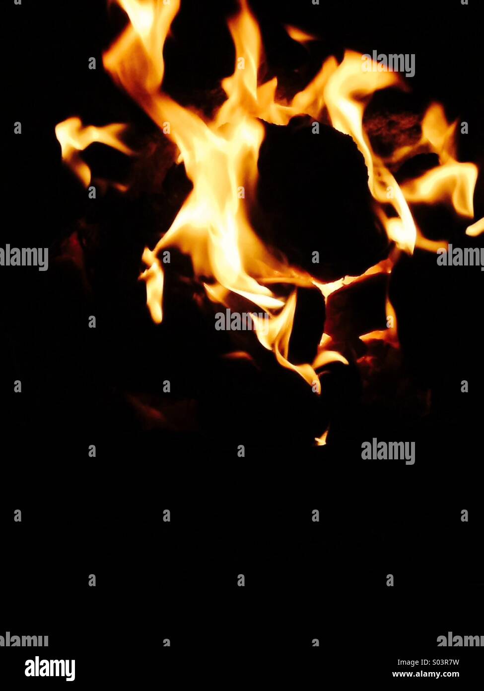 Burning coal in fireplace Stock Photo