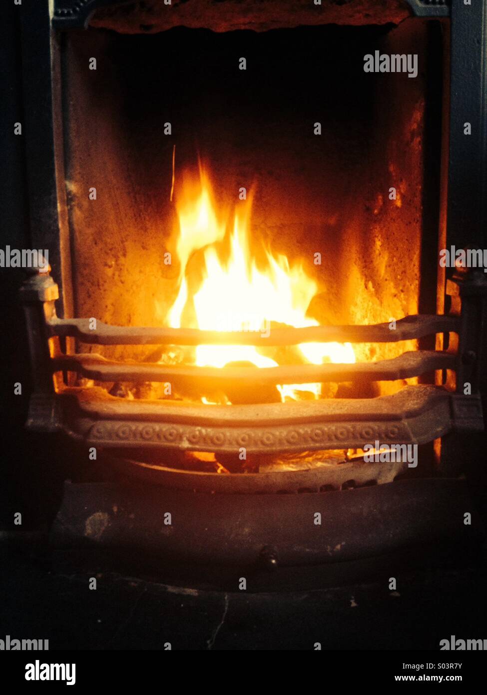 Fireplace with coal burning fire Stock Photo