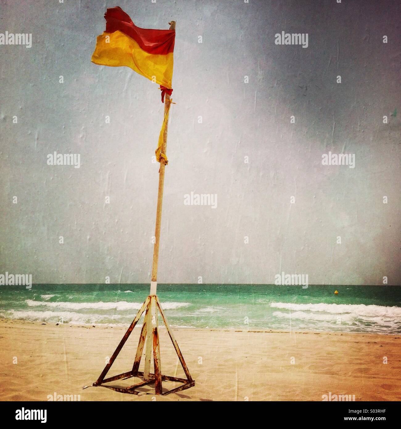 A safety flag on the beach. Abu Dhabi. United Arab Emirates. - Smartphone Captured Stock Image