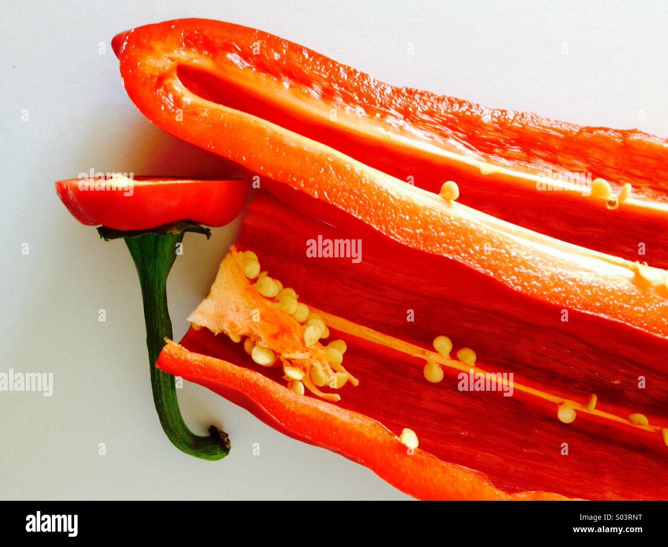 Red pepper cut with seeds and green stalk - Smartphone Captured Stock Image