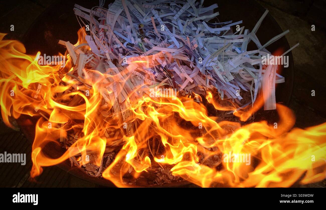 Destruction of Confidential Information by Shredding Paper & then Burning it. Photo Credit - © COLIN HOSKINS. - Smartphone Captured Stock Image